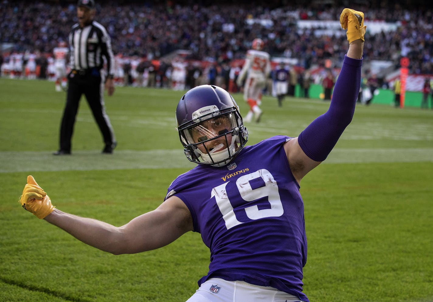 Vikings wide receiver Adam Thielen (19) celebrated with a soccer-style slide after catching an 18-yard touchdown pass in the second quarter against the Browns at Twickenham Stadium.