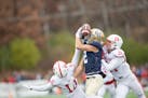 Joey Kidder jumped up to catch pass for Bethel against St. John’s defensive backs Mateo Cisneros (10) and and Cayden Saxon (24) on Saturday.
