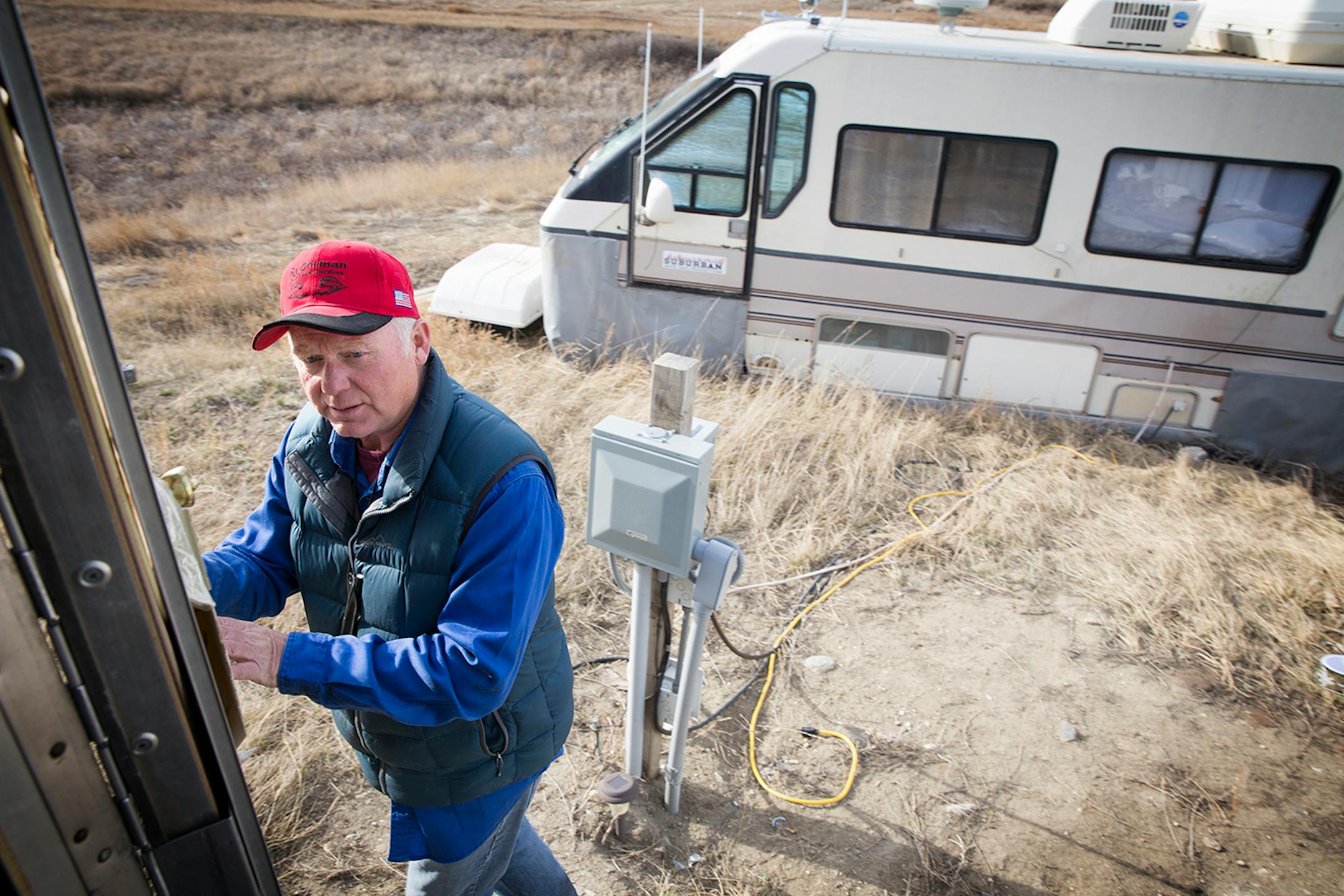 Michael Teague lost his job on an oil rig, and found a job almost immediately working on the rail lines in Williston, North Dakota on Thursday, April 2, 2015. Teague lives in an RV with his girlfriend and cat on land west of Williston.