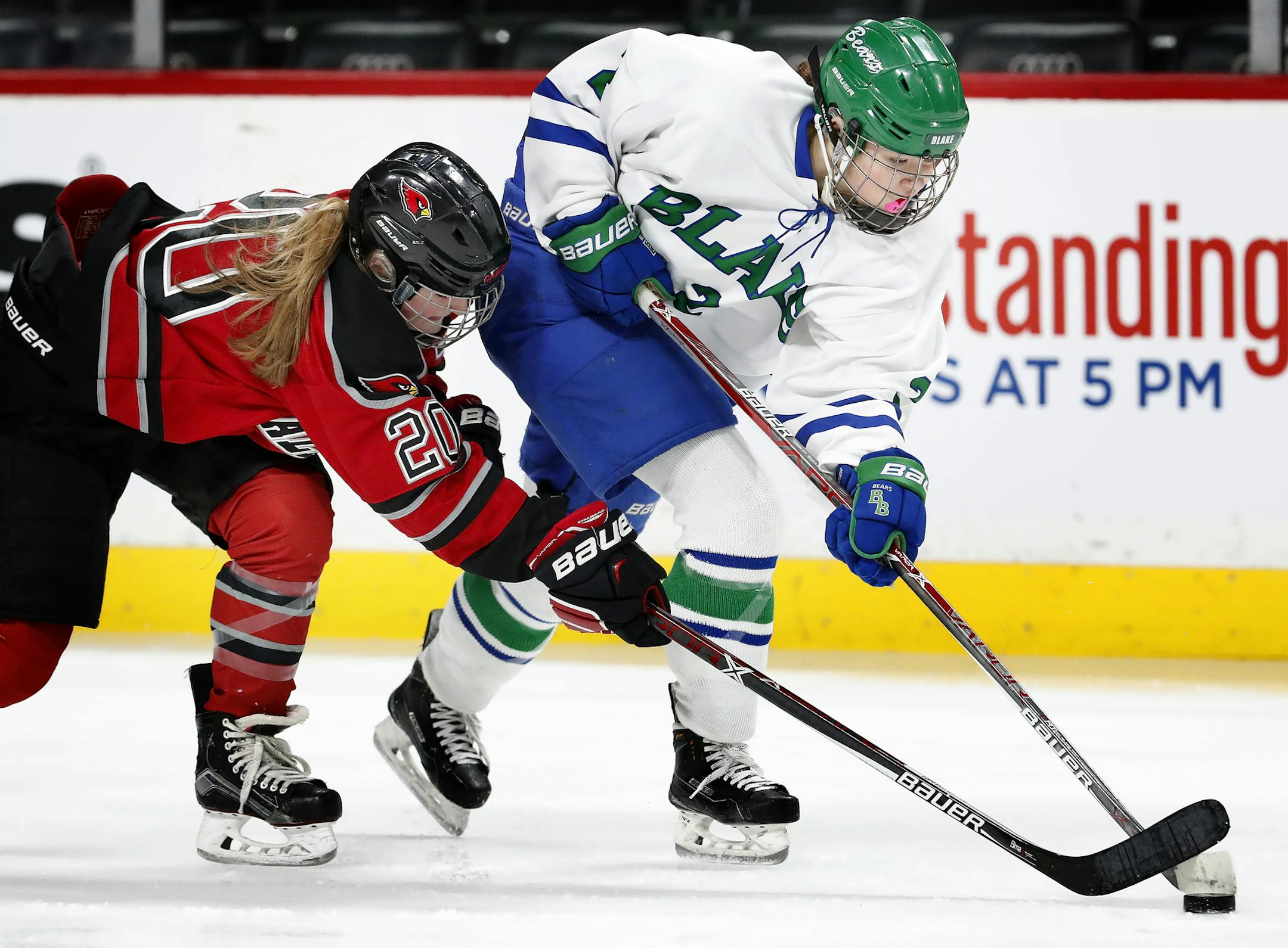 Alexis Heckert (20) of Alexandria and Addie Burton (2) of Blake fought for the puck in the first period. ] CARLOS GONZALEZ • cgonzalez@startribune.com - February 21, 2017, St. Paul, MN, Xcel Energy Center, NHL, Hockey, Chicago Blackhawks at Minnesota Wild
