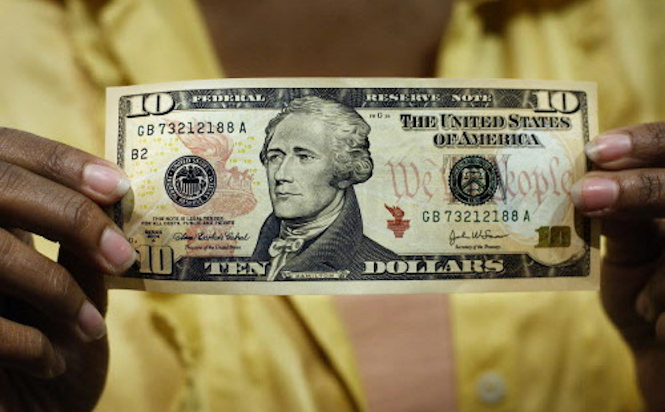 FILE - In this March 2, 2006 file photo, a $10 bill, featuring a likeness of Andrew Hamilton, the first U.S. Treasury secretary, is displayed at the National Archives gift shop, in Washington. Former Federal Reserve chief-turned blogger Ben Bernanke on Monday, June 22, 2015 called for the U.S. Treasury to abandon plans to drop Hamilton from his featured spot on the $10 bill and to dump Andrew Jackson from the $20 bill instead. (AP Photo/J. Scott Applewhite, File)