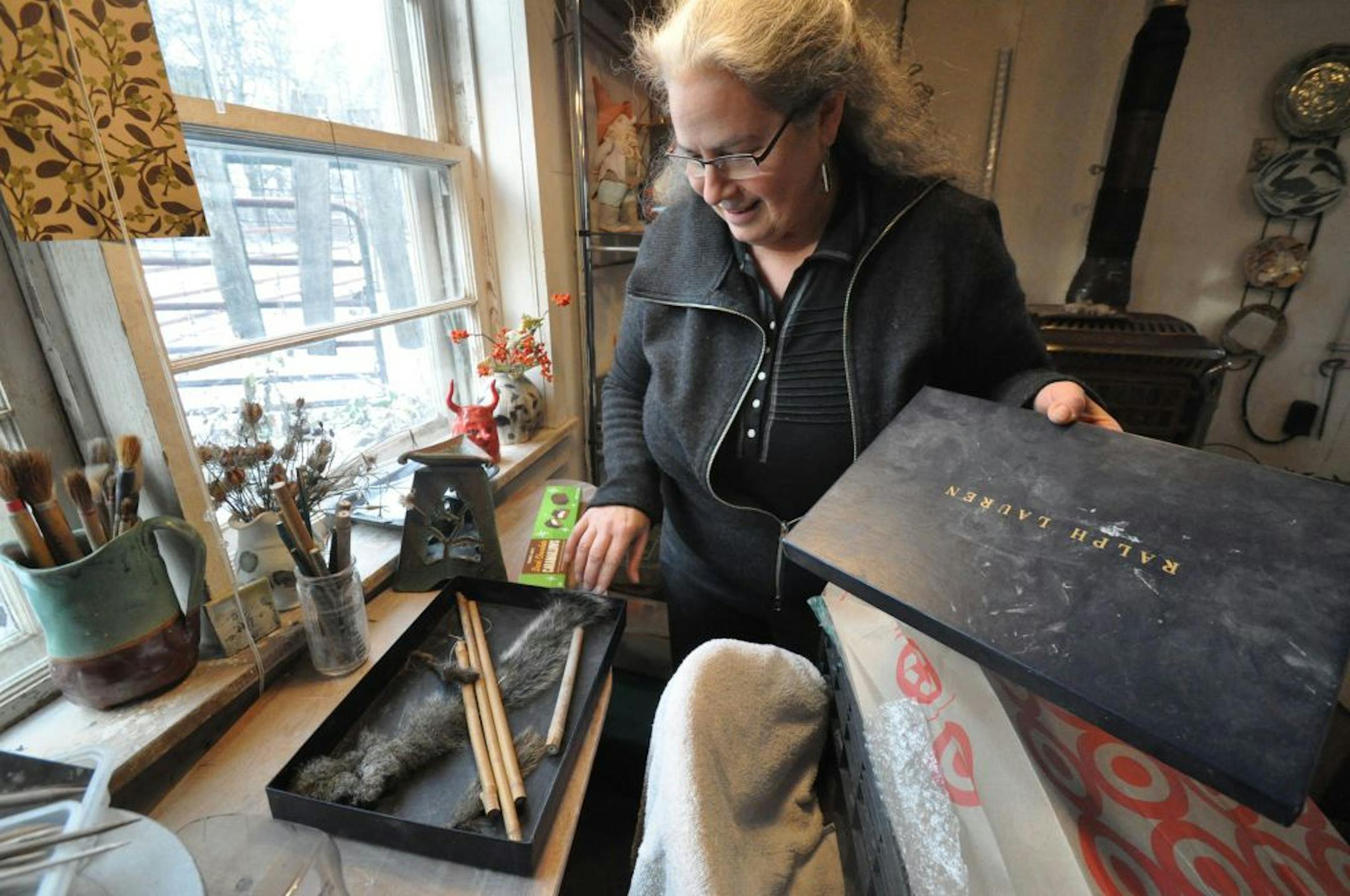 Photo by Liz Rolfsmeier 102: New Northfield resident Glynnis Lessing showed supplies used during a recent workshop in her milk house studio, where she and other local potters created brushes from fox, deer, and squirrel tails.