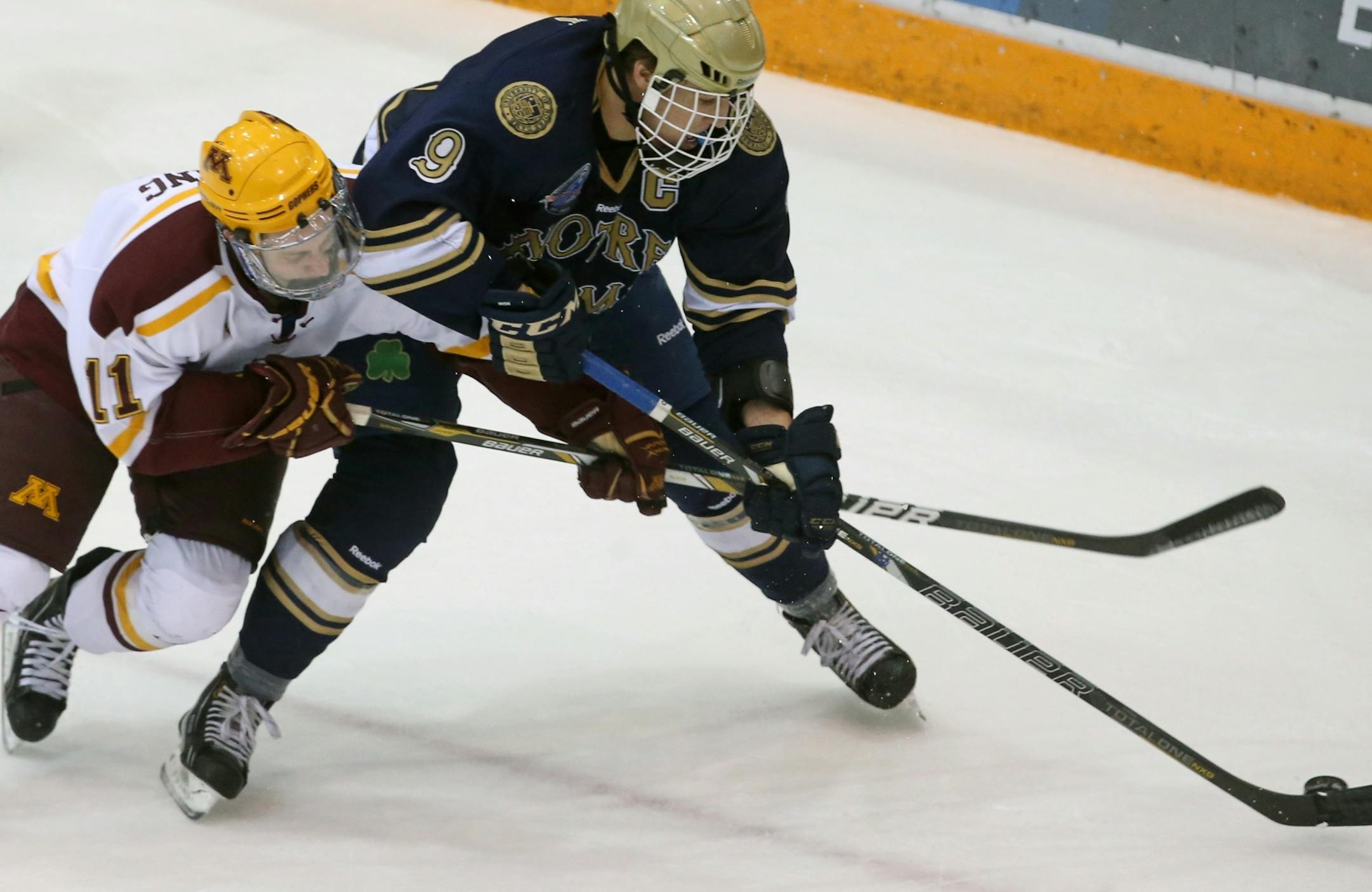 Sam Warning battles for the puck with Irish center Anders Lee.