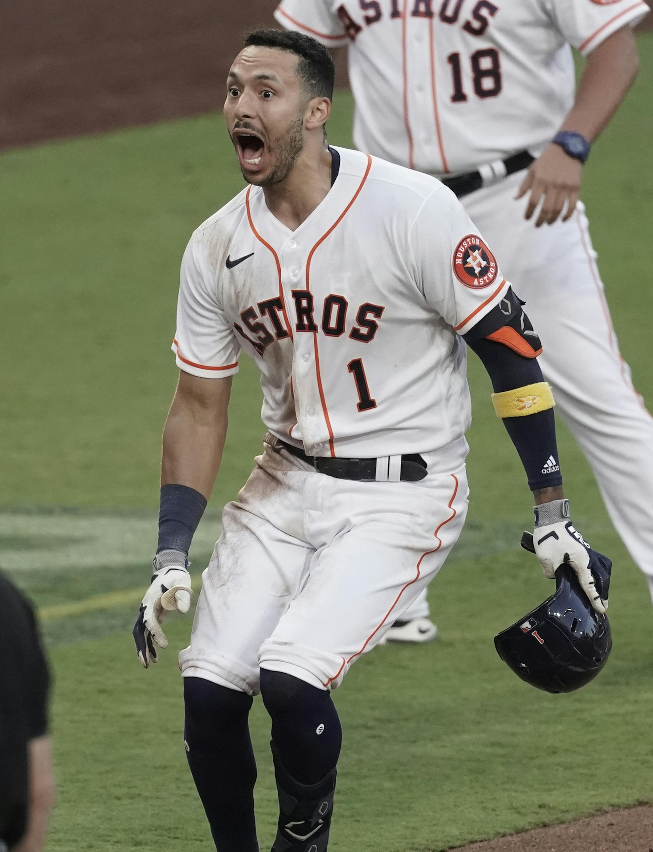 Houston Astros Carlos Correa reacts after his walk off home run during the ninth inning in Game 5 of a baseball American League Championship Series, Tuesday, Dec. 15, 2020, in San Diego. The Astros defeated the Rays 4-3 and the Rays lead the series 3-2 games. (AP Photo/Ashley Landis)