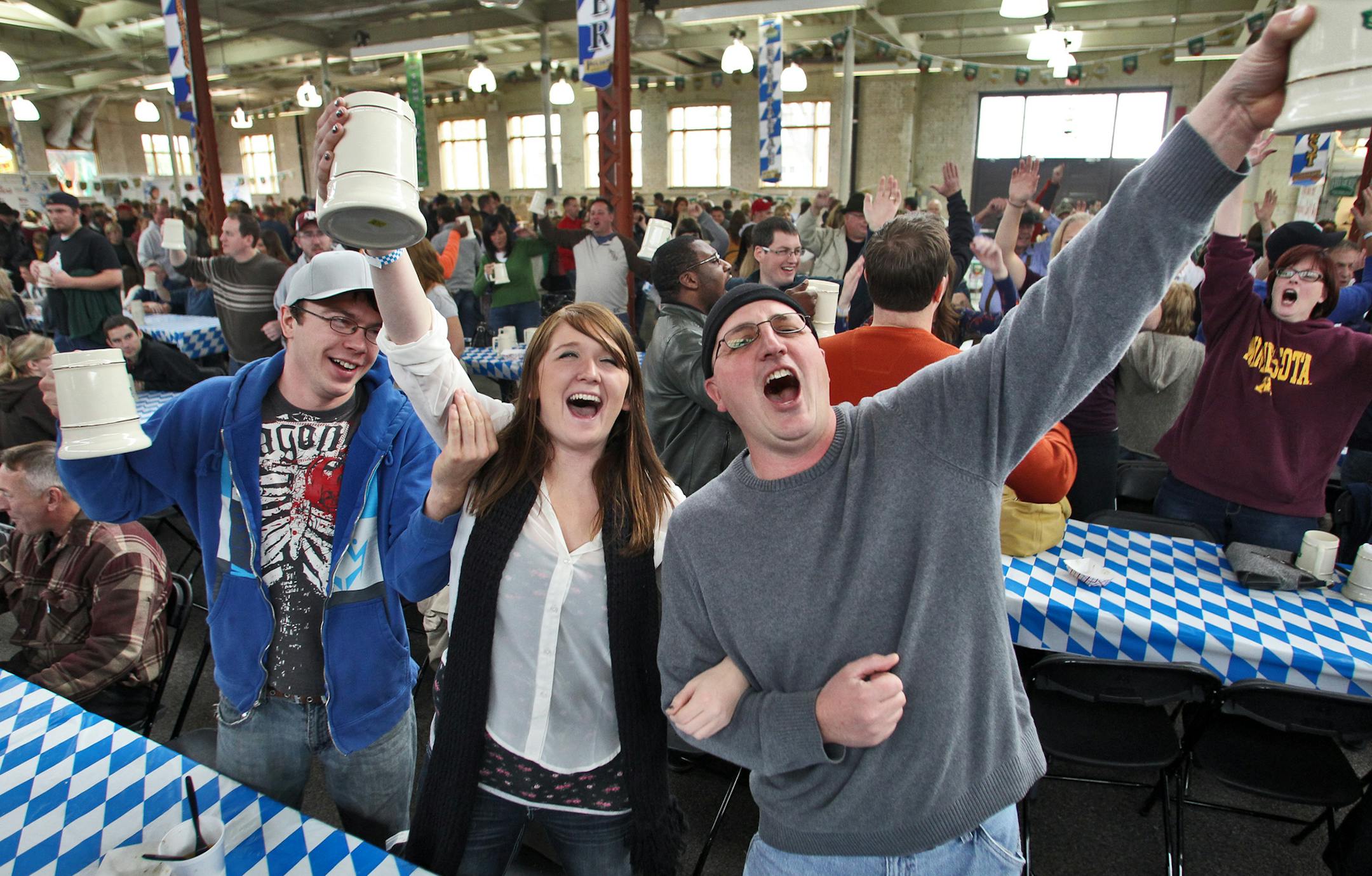 Twin Cities Oktoberfest celebration at Minnesota State Fairgrounds. Music was provided by the Bavarian Musikmeisters band with dancing performed by the S.G. Edelweiss dance group of St. Paul. Matt Rinkenberger of Roseau, Meghan Nelson of St. Paul and Randy Bougie of Falcon Heights raised their beer steins in celebration of a Bavarian drinking song played by the Musikmeisters band. (MARLIN LEVISON/STARTRIBUNE(mlevison@startribune.com (cq ) ORG XMIT: MIN1210061716551509