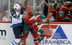 Winnipeg Jets right wing Joel Armia (40) and Minnesota Wild center Jordan Schroeder (10) vie for the puck during the first period of an NHL preseason 