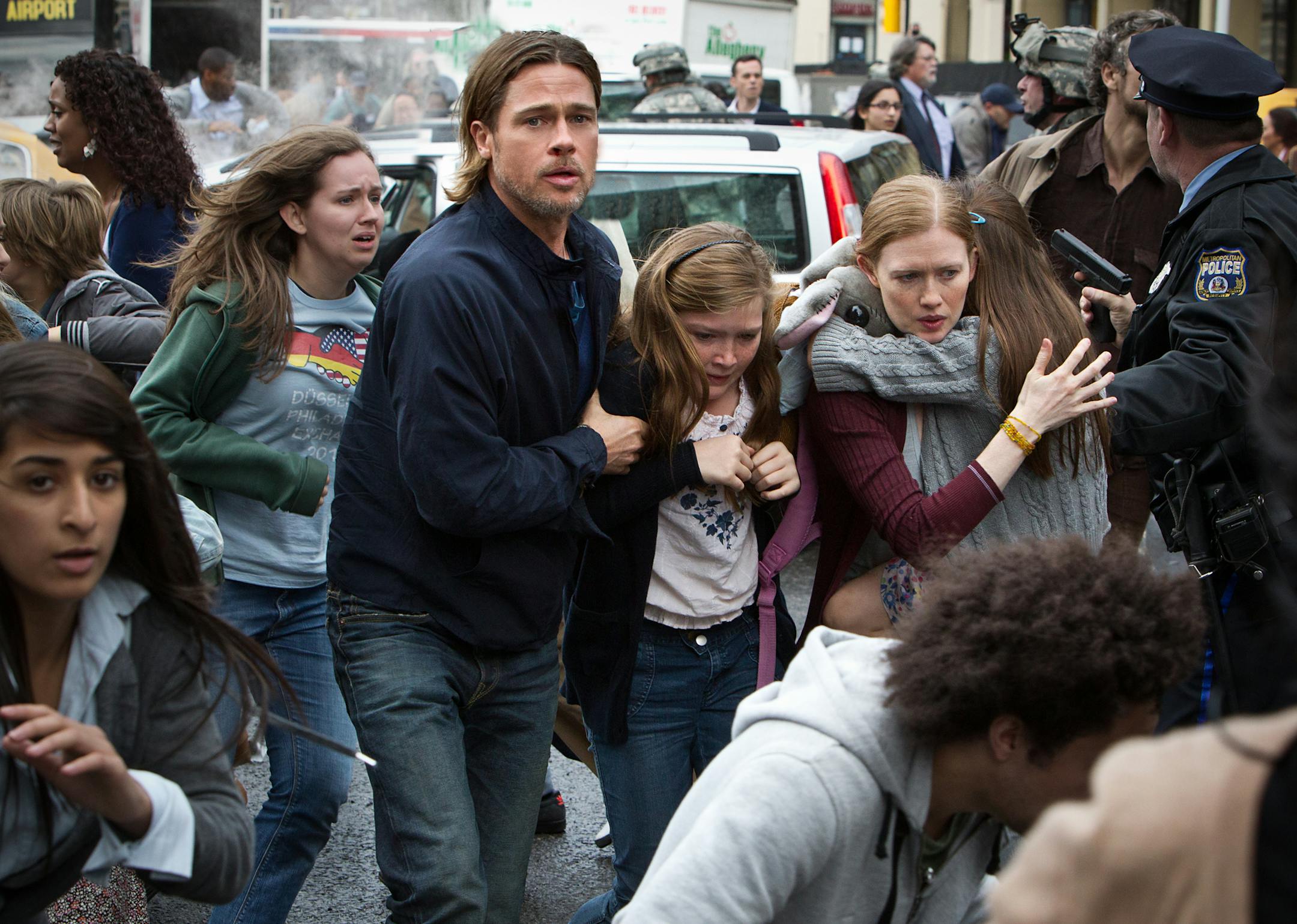 This publicity image released by Paramount Pictures shows, from center left, Brad Pitt as Gerry Lane, Abigail Hargrove as Rachel Lane, and Mireille Enos as Karin Lanein a scene from "World War Z." In a small-scale marketing experiment, for $50, some fans got to see Brad Pitt's hotly anticipated zombie thriller "World War Z" before all their friends. They also got 3D glasses to keep, popcorn, a poster, and a promised copy of the DVD when it comes out. (AP Photo/Paramount Pictures, Jaap Buitendijk