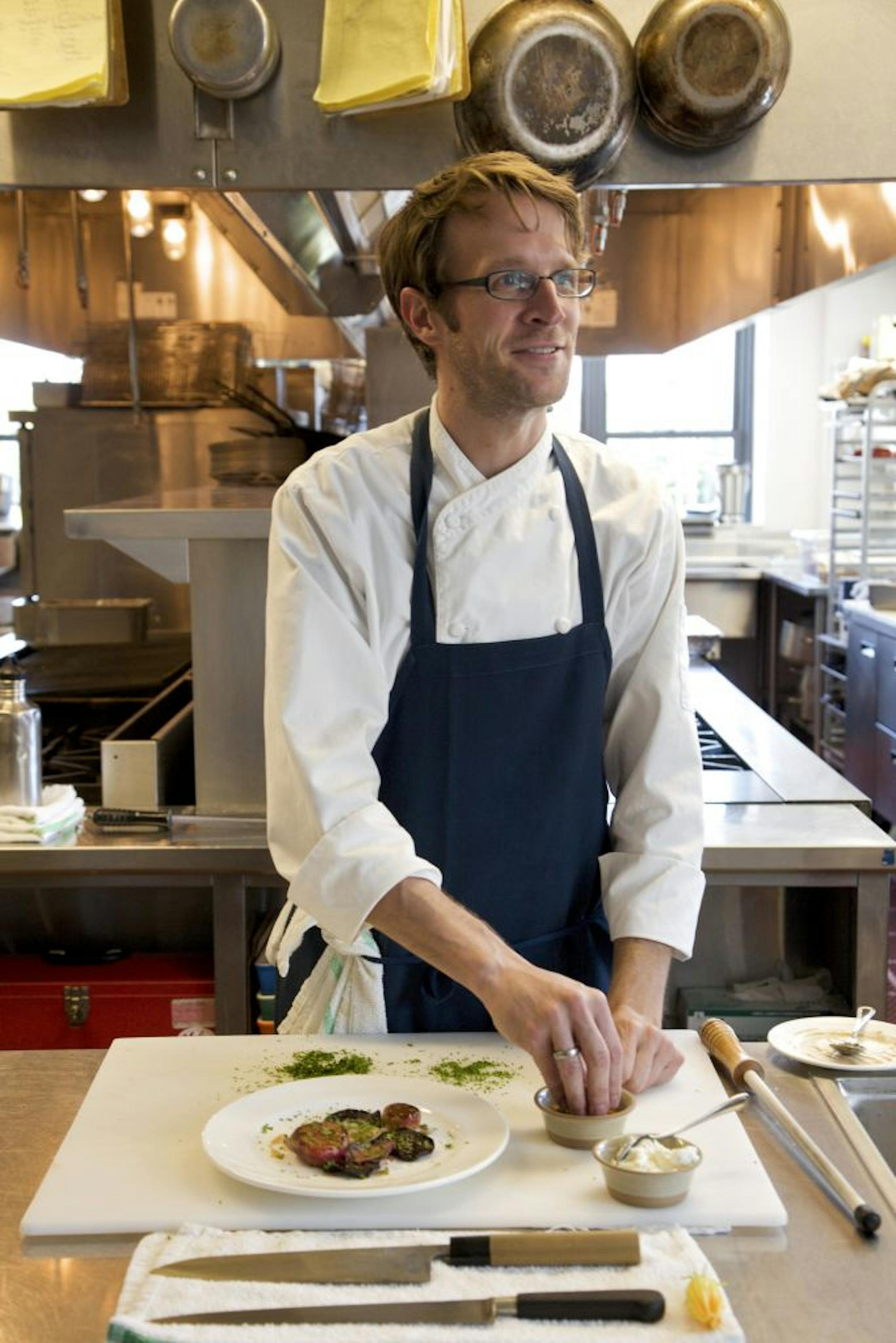 Paul Berglund, a chef at the Bachelor Farmer, a restaurant that blends Scandinavian design, prepares a dish at the restaurant in Minneapolis, July 23, 2012. Cooks in the Twin Cities are suddenly embracing Nordic heritage based on cold-weather crops, traditional foodways and naturalistic presentations.