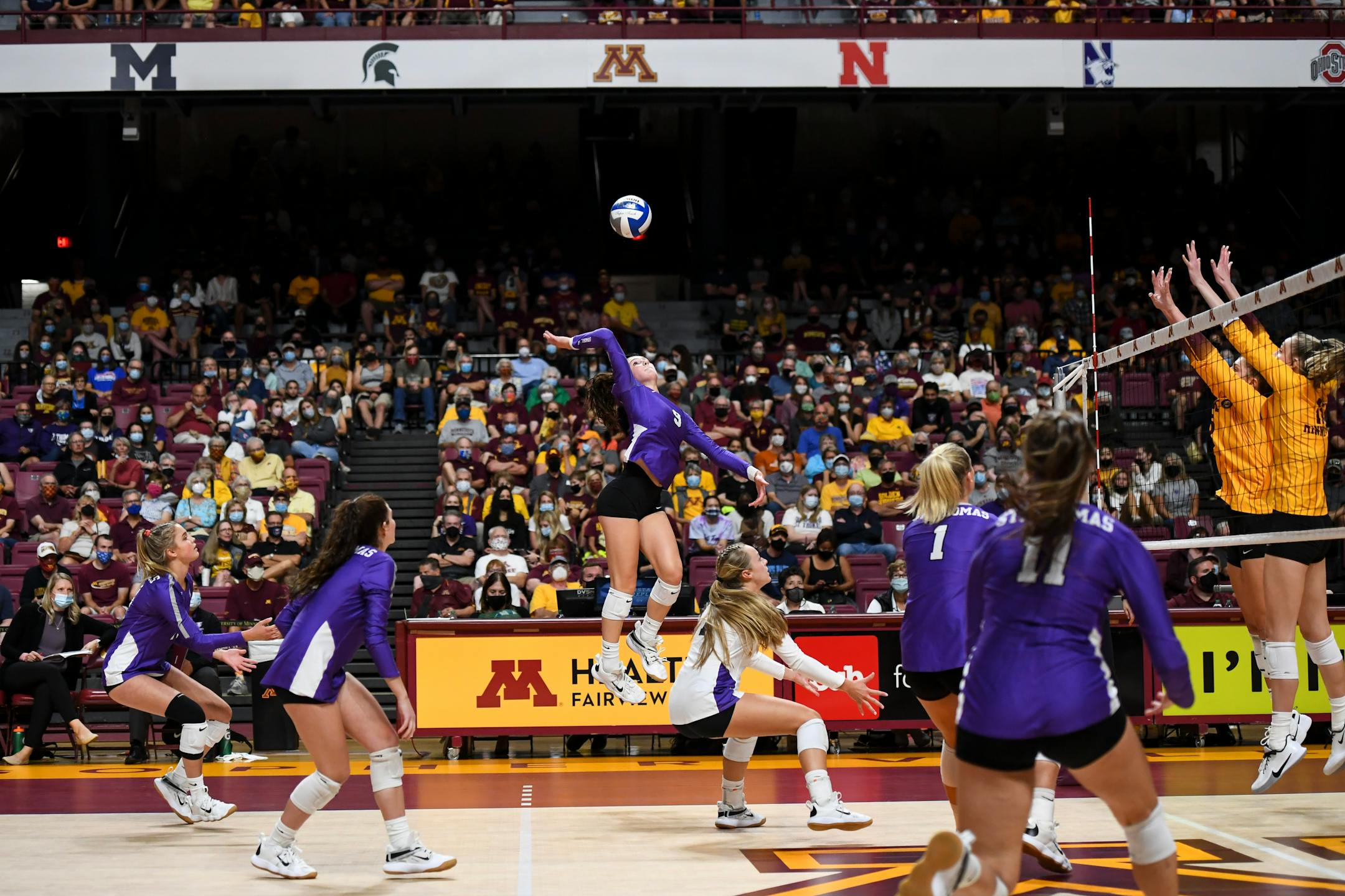 St. Thomas outside hitter Lauren Galvin (9) spiked the ball during the third set against the University of Minnesota Gophers.