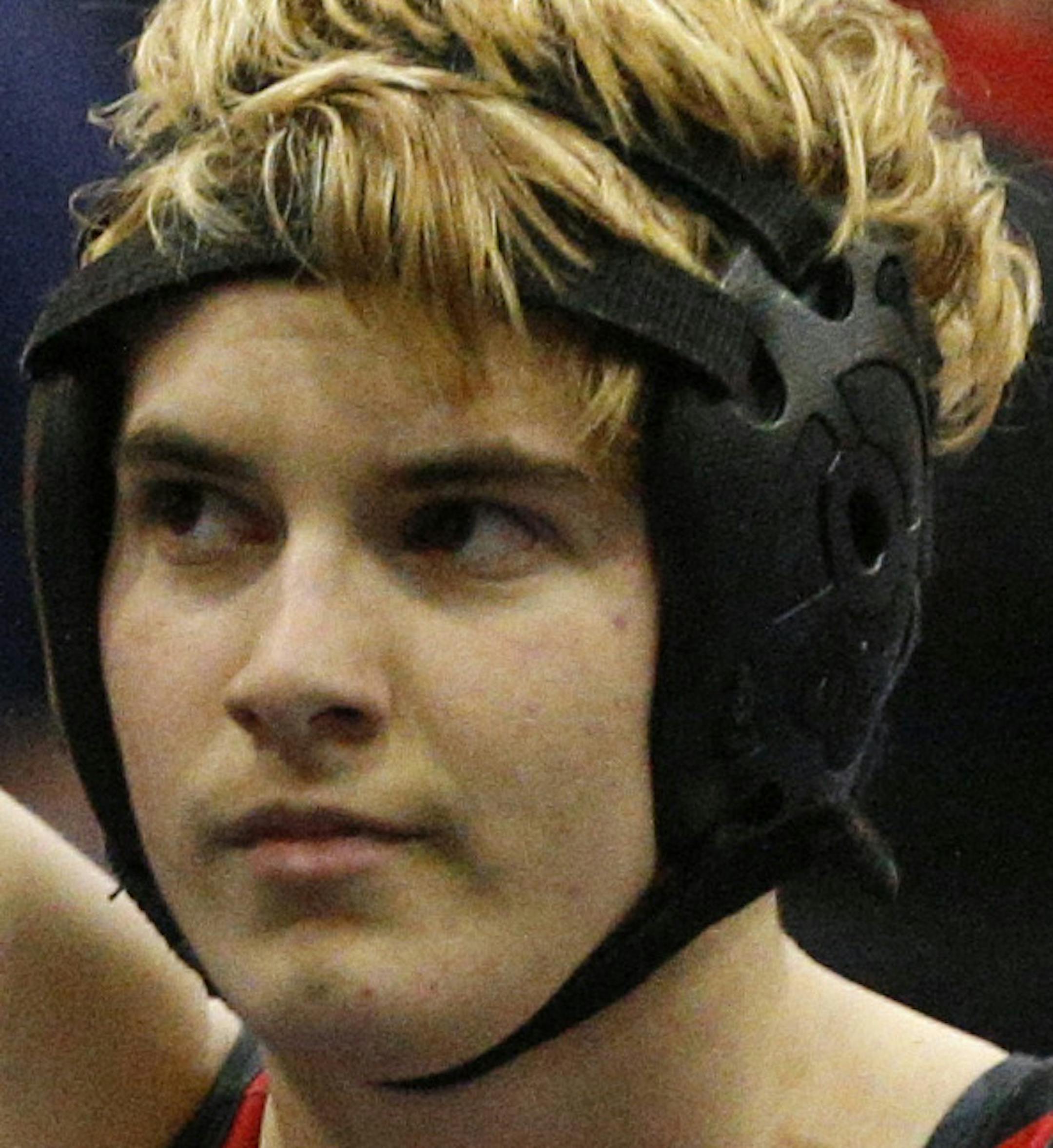 In this Feb. 18, 2017 photo, Euless Trinity's Mack Beggs is announced as the winner of a semifinal match after Beggs pinned Grand Prairie's Kailyn Clay during the finals of the UIL Region 2-6A wrestling tournament at Allen High School in Allen, Texas. Beggs, who is transgender, is transitioning from female to male, won the girls regional championship after a female opponent forfeited the match. (Nathan Hunsinger/The Dallas Morning News via AP)