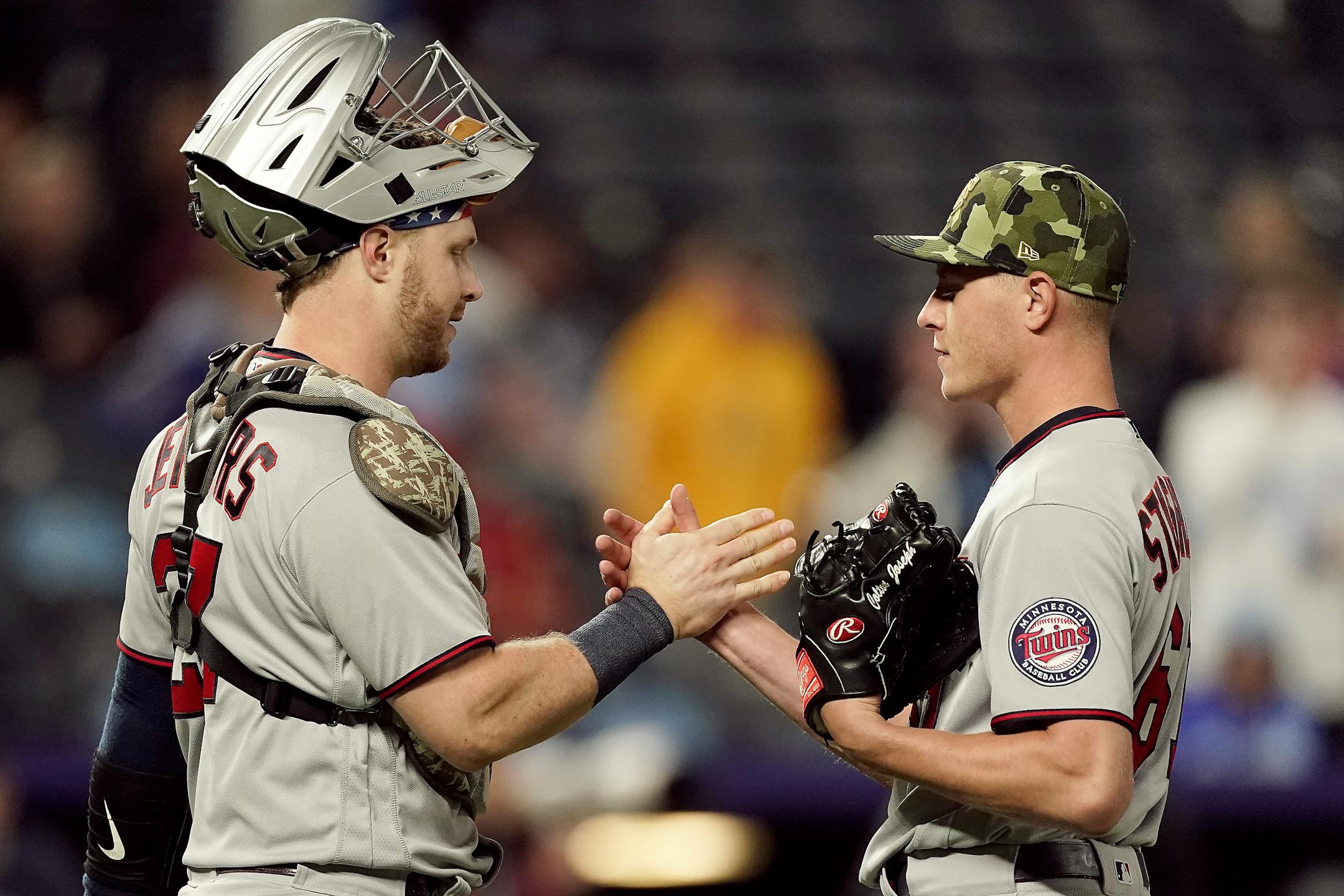Minnesota Twins catcher Ryan Jeffers and relief pitcher Cody Stashak celebrate after their baseball game against the Kansas City Royals Saturday, May 21, 2022, in Kansas City, Mo. The Twins won 9-2. (AP Photo/Charlie Riedel)