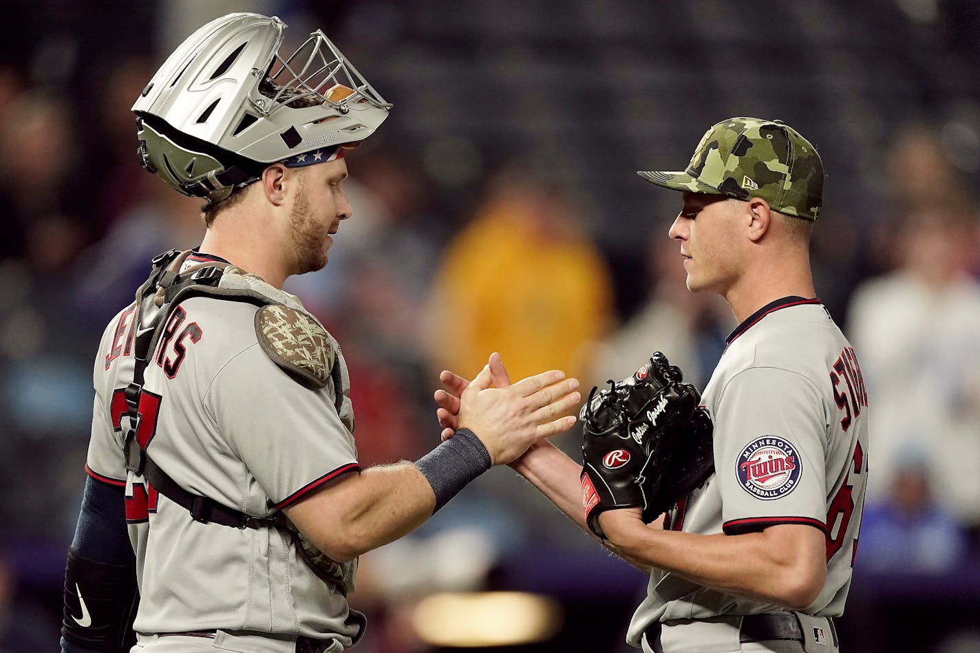 Minnesota Twins catcher Ryan Jeffers and relief pitcher Cody Stashak celebrate after their baseball game against the Kansas City Royals Saturday, May 21, 2022, in Kansas City, Mo. The Twins won 9-2. (AP Photo/Charlie Riedel)