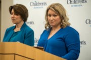 U.S. Sen. Amy Klobuchar, left, and Janet McGee, whose son Ted died in a furniture tip-over, hold a news conference at Children’s Minnesota Hospital 