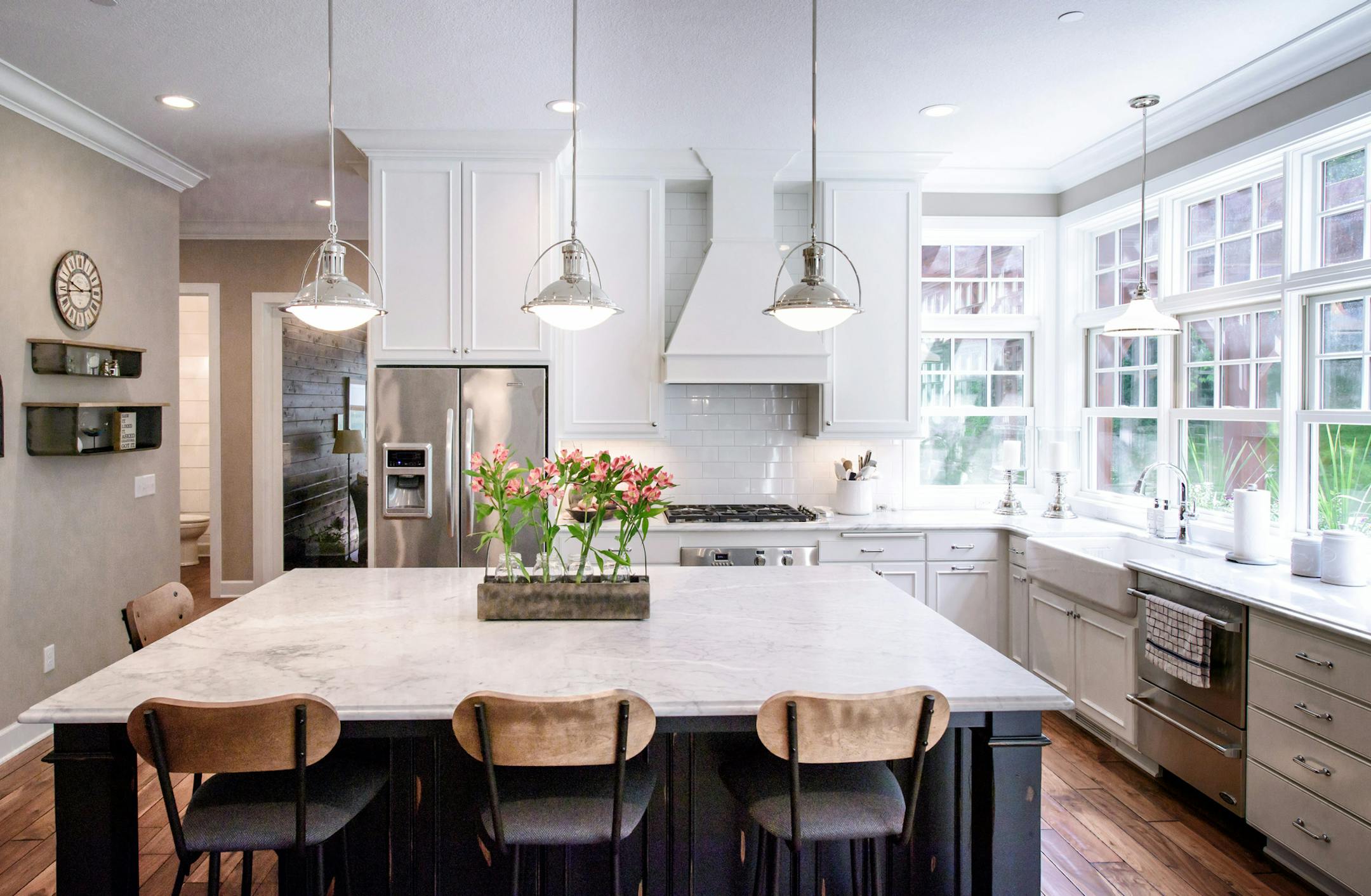 The light, bright farmhouse-style kitchen has a big center island and opens to the dining area.