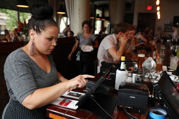 Server Talia Bartley rang up a table at Saint Dinette in St. Paul.
