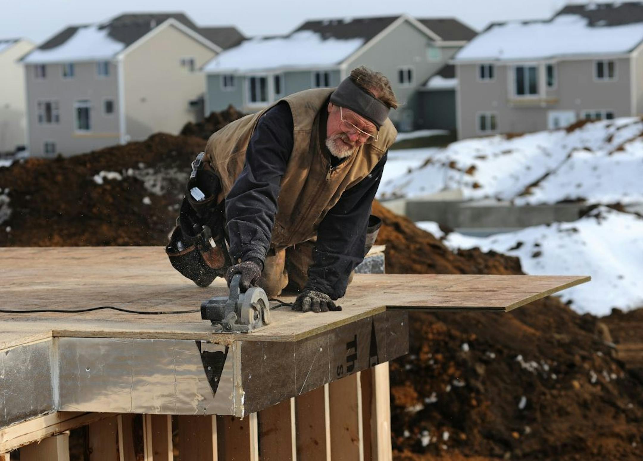 Single-family homes in the center of this Lakeville development are being built by Keyland Homes on lots where townhouses were planned. The lots were re-platted because demand for townhouses has withered. David Christiansen of Spooner, Wis., worked framing a new house on Hytrail Circle this week.
