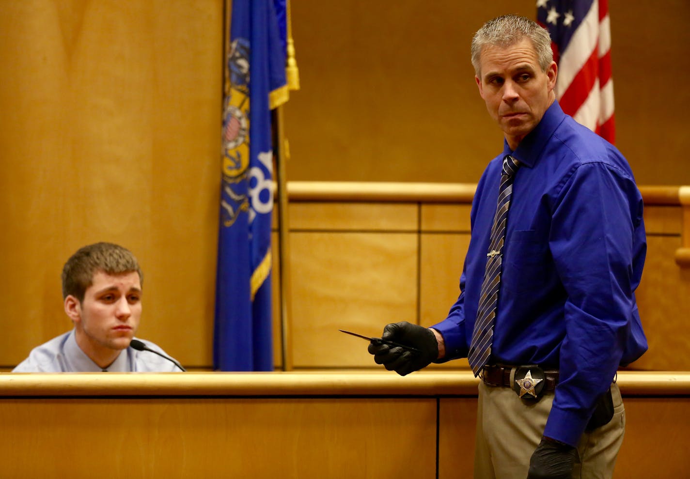 Investigator Rick Gearhart, the lead investigator with the Polk County sheriff's office shows the knife that Levi Acre-Kendall used to stab Peter Kelly during Acre-Kendall's testimony.