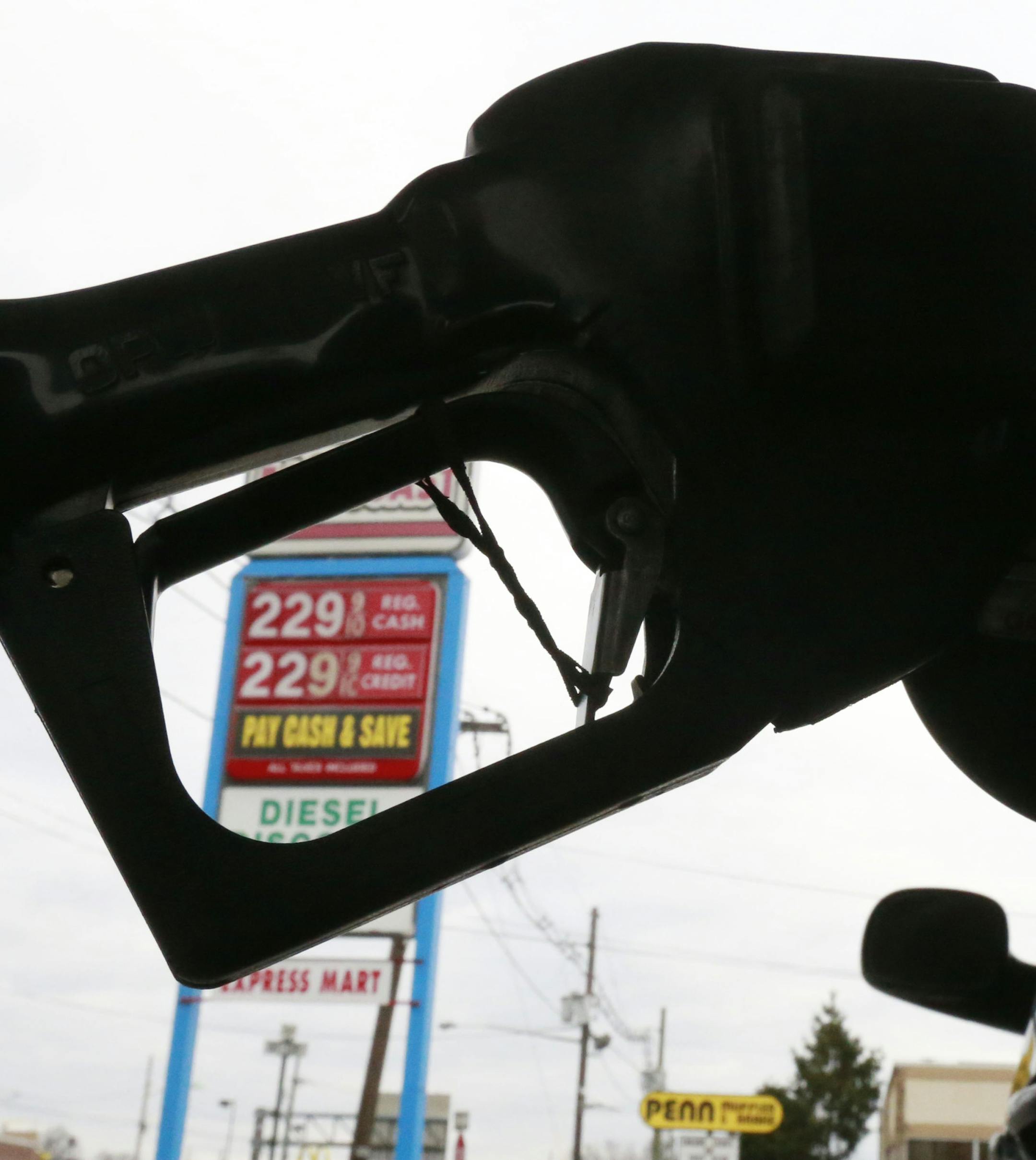FILE - In this Dec. 18, 2014 file photo, gas is pumped into a car at the Eastcoast filling station in Pennsauken N.J. In the second half of 2014, the price of oil dropped by half, to depths not seen since May of 2009 when the U.S. was in the Great Recession. By December, some drivers even saw a price at the pump that started with a $1. (AP Photo/Matt Rourke, File)
