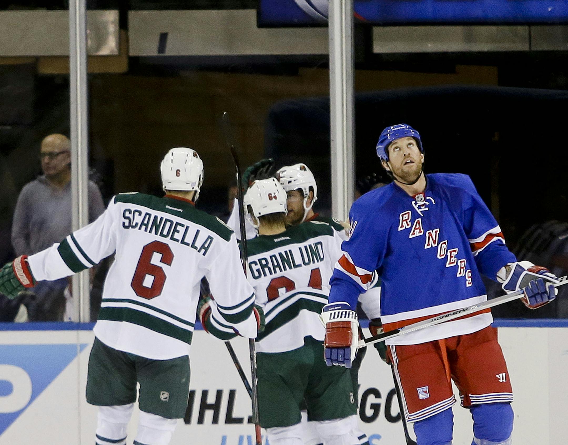New York Rangers left wing Ryan Malone, right, skates away from Minnesota Wild's Marco Scandella (6), Mikael Granlund (64) and Jason Pominville after Pominville scored a goal during the second period of an NHL hockey game Monday, Oct. 27, 2014, in New York.