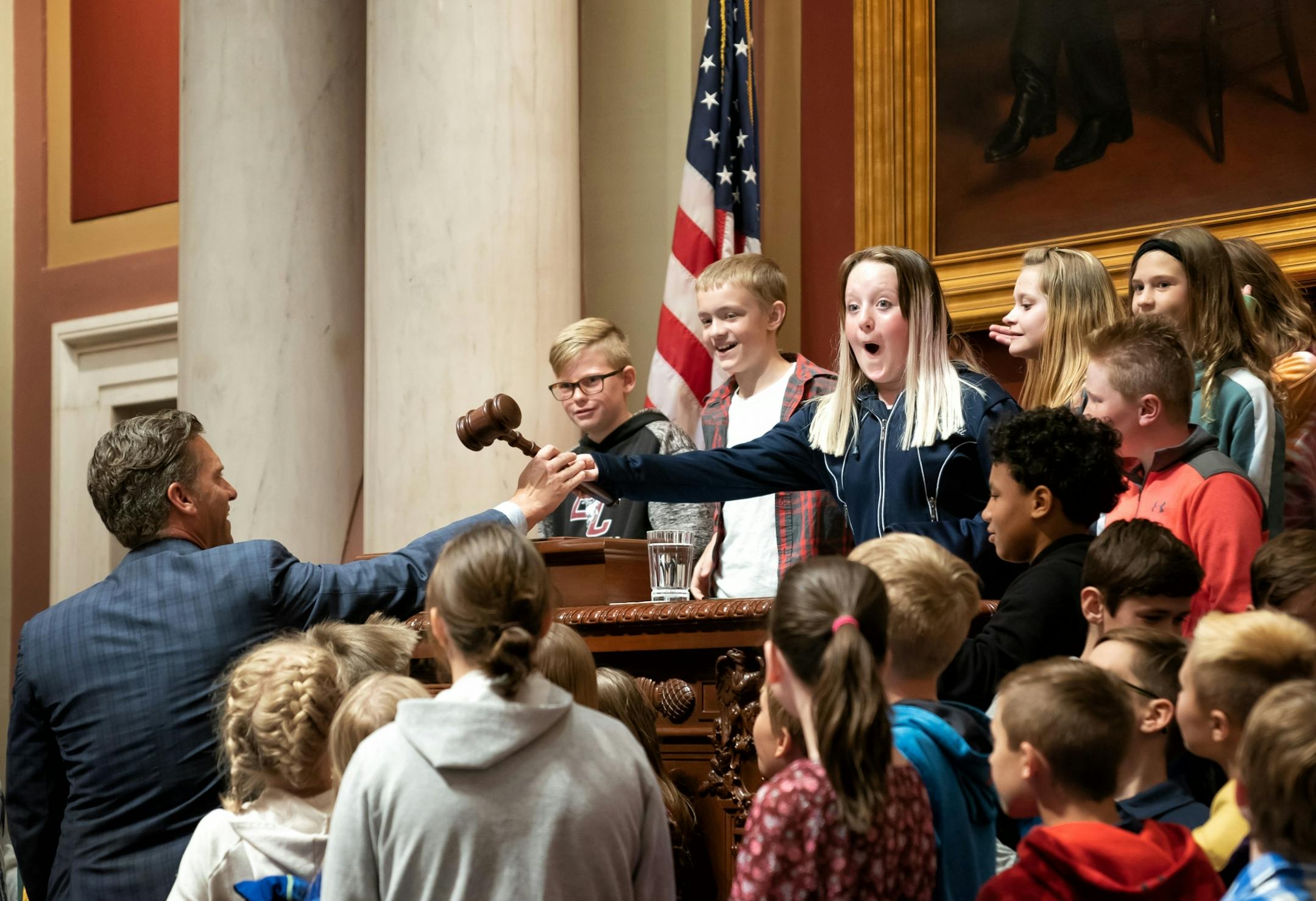 Lydia Segelstrom, 11, was surprised and maybe a little scared at the sound made from the Speaker's gavel when Minority Leader Kurt Daudt let her try it during a tour. The group of fifth graders was visiting from Saint Francis Elementary in Daudt's district.