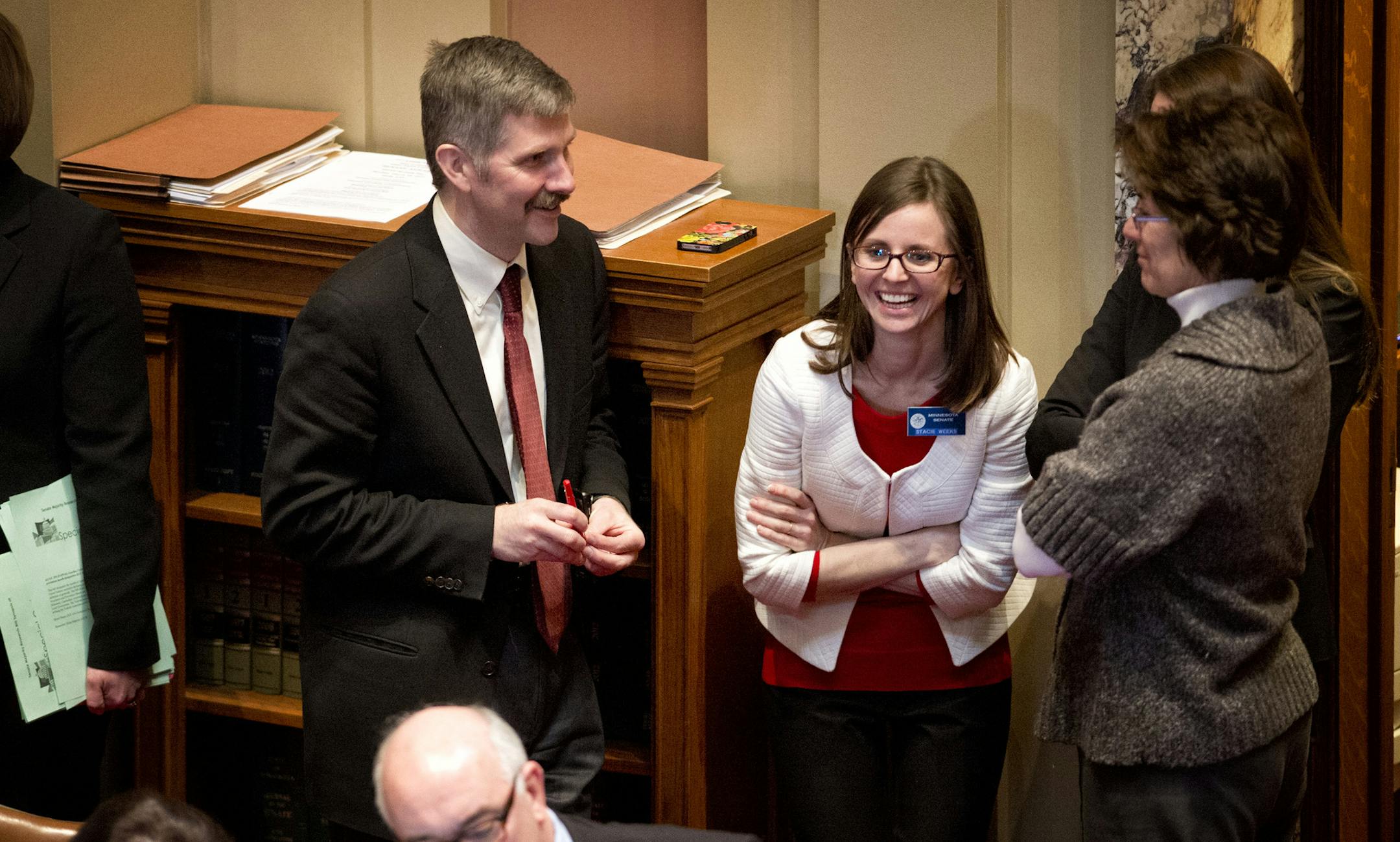 Bill author Sen. Tony Lourey laughed with staffers including Stacie Weeks, center after the final vote. The Minnesota Senate passed the health insurance exchange bill by a straight party line vote 39-28. Next stop is Governor Dayton's desk. Monday, March 18, 2013. ] GLEN STUBBE * gstubbe@startribune.com