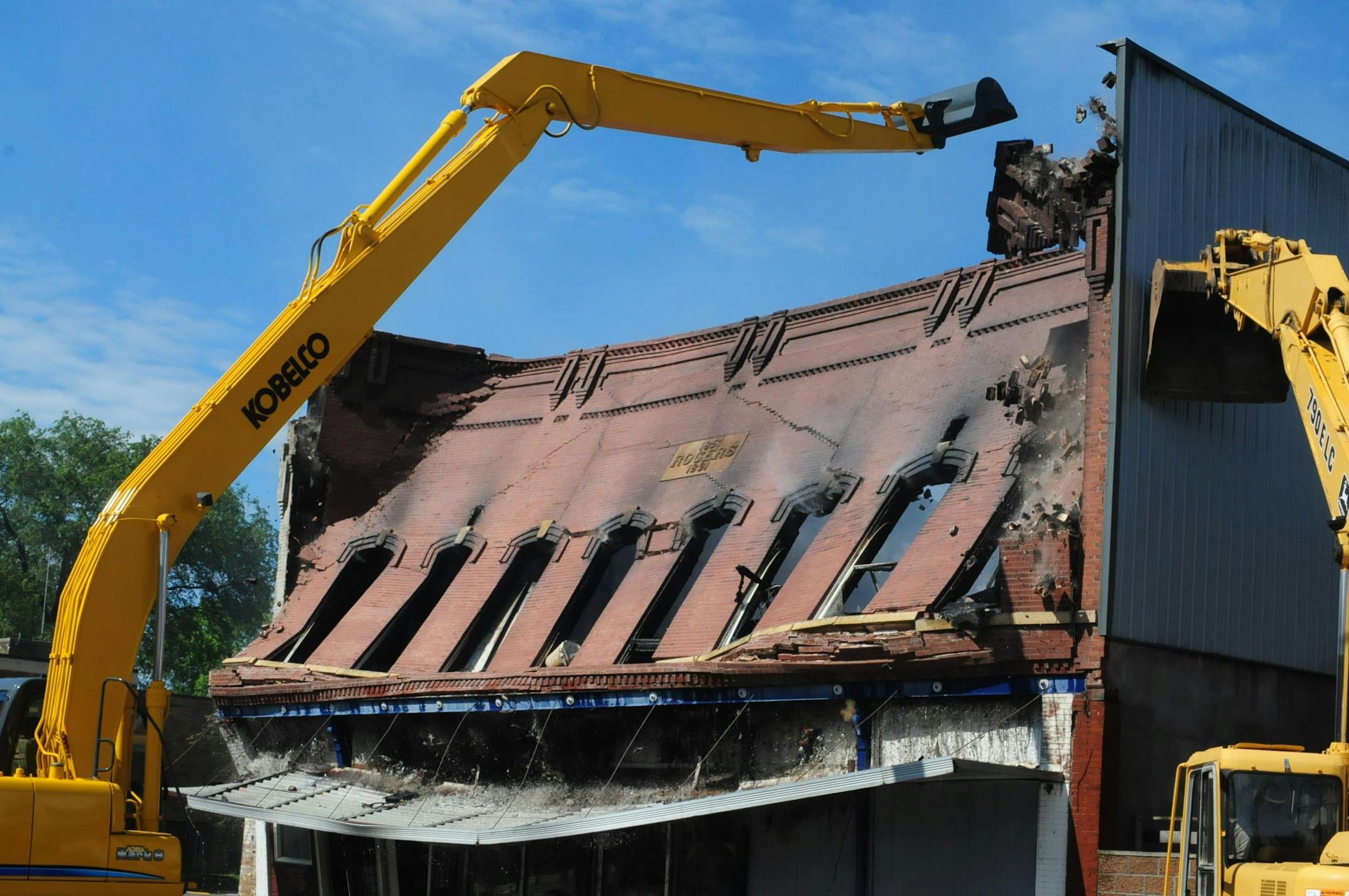 Heavy equipment knocked down what was left of a building that caught fire Thursday morning in Waterville, Minn.