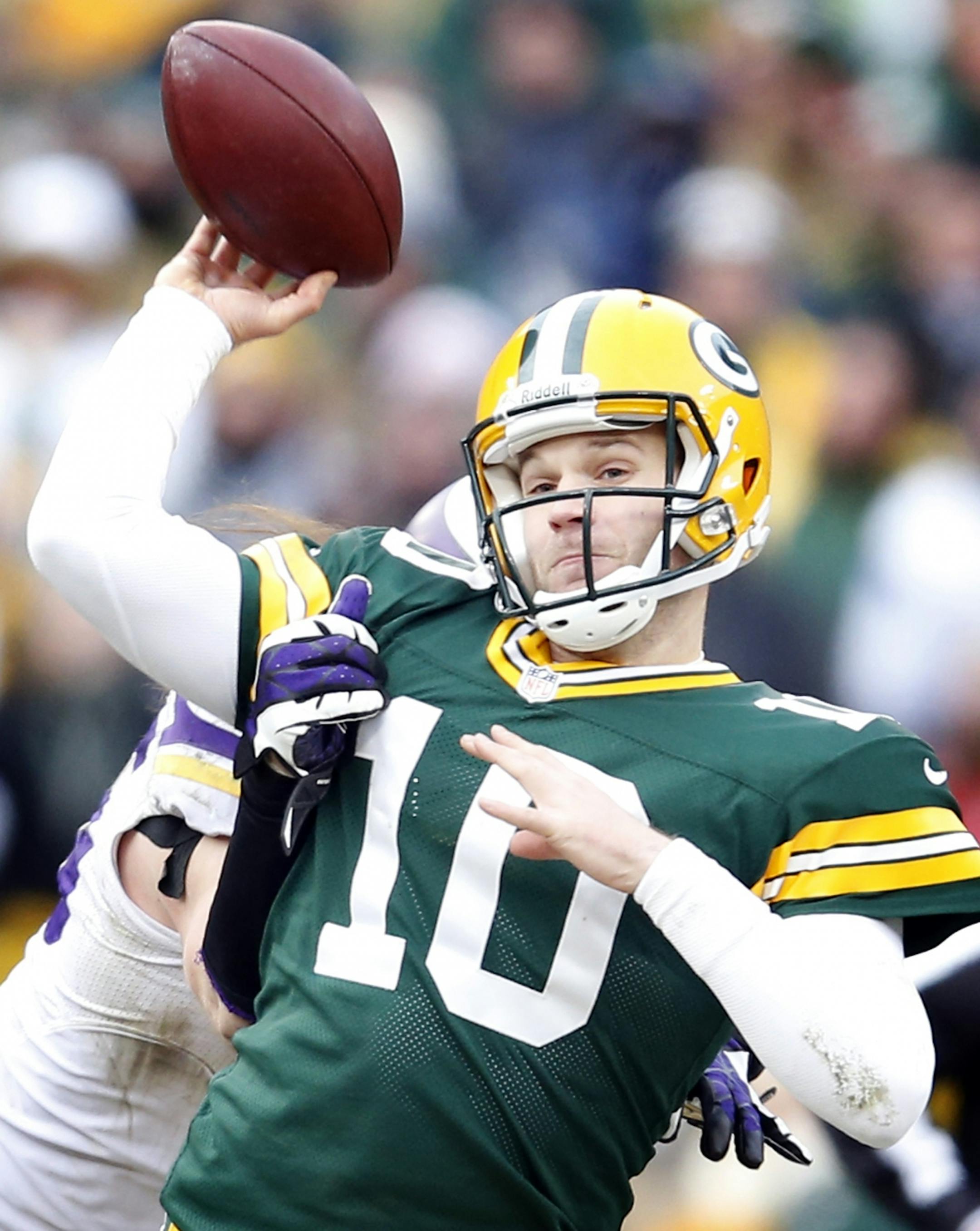 Packers quarterback Matt Flynn was pressured by Vikings defensive end Brian Robison (behind) in the fourth quarter.