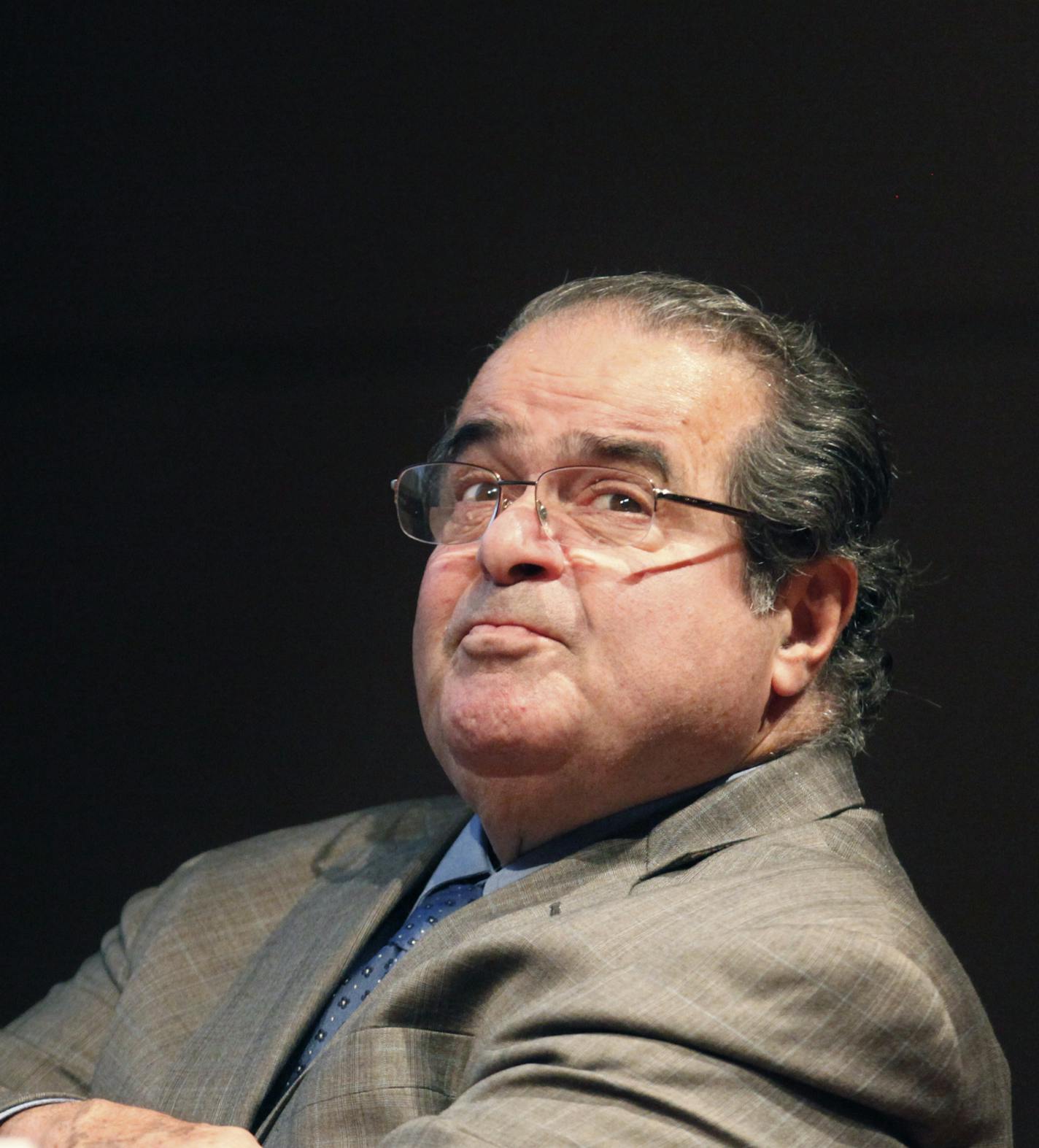 FILE - In this Oct. 18, 2011 file photo, U.S. Supreme Court Justice Antonin Scalia looks into the balcony before addressing the Chicago-Kent College Law justice in Chicago. On Saturday, Feb. 13, 2016, the U.S. Marshals Service confirmed that Scalia died at the age of 79. (AP Photo/Charles Rex Arbogast, File)