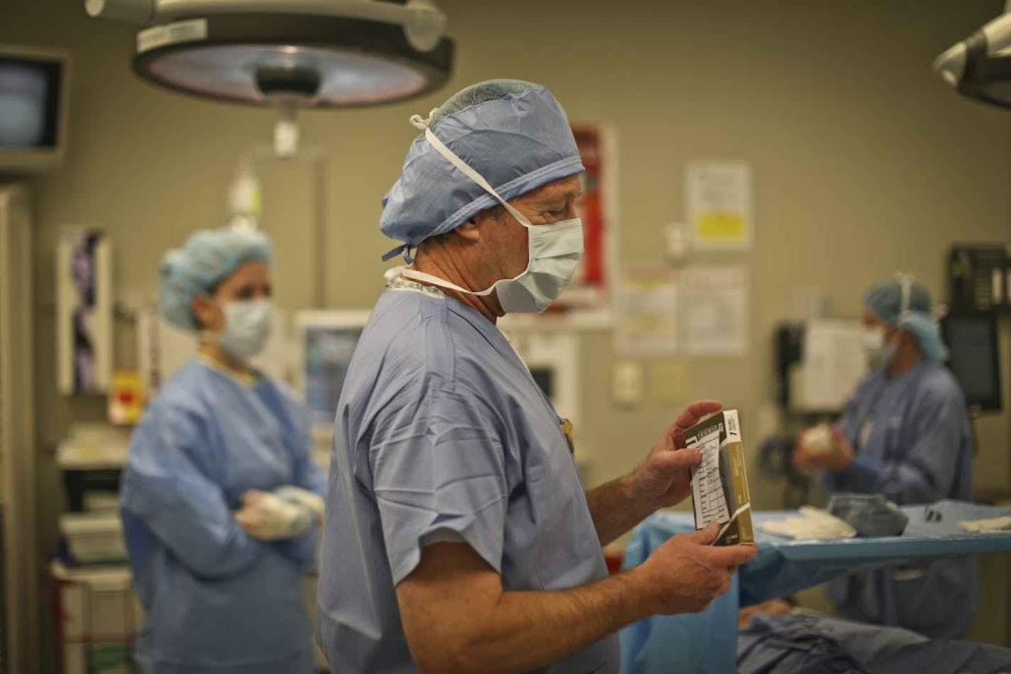 Phillips Eye Institute uses a series of protocols to actively prevent medical errors. In this picture, Dr. Jeffrey Christensen does what's called a "time out" where the surgical team meet and all double check that they have the correct materials including the intraocular lenses he is holding (there are hundreds of brands and powers of intraocular lenses), before a cateract surgery at the Phillips Eye Institute in Minneapolis, Minn. on Wednesday, January 30, 2013.