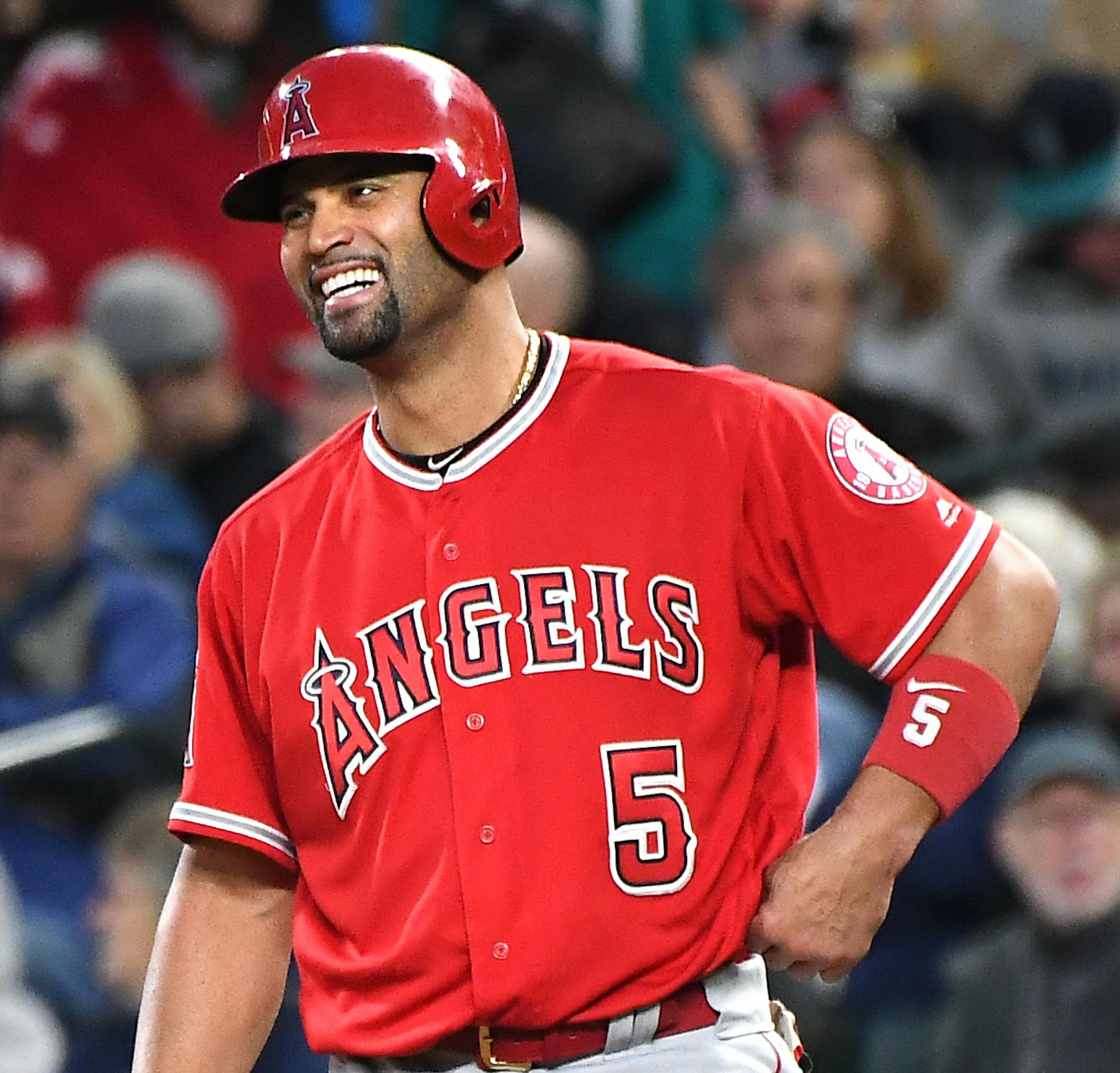 The Los Angeles Angels' Albert Pujols celebrates at first base after his 3,000th career hit, a fifth-inning single in a 5-0 win against the Seattle Mariners on Friday, May 4, 2018, at Safeco Field in Seattle. (Wally Skalij/Los Angeles Times/TNS)
