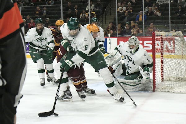 Bemidji State Beavers forward Jay Dickman (6) recovers the puck after an attack from Minnesota.