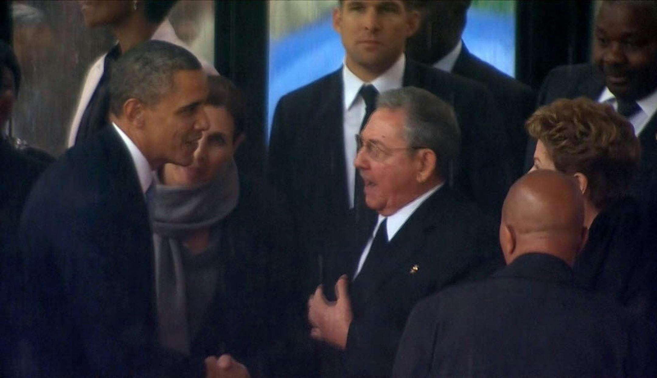 Screen shot from TV of President Obama shaking hands with Cuban President Raul Castro at the memorial service for Nelson Mandela in South Africa.