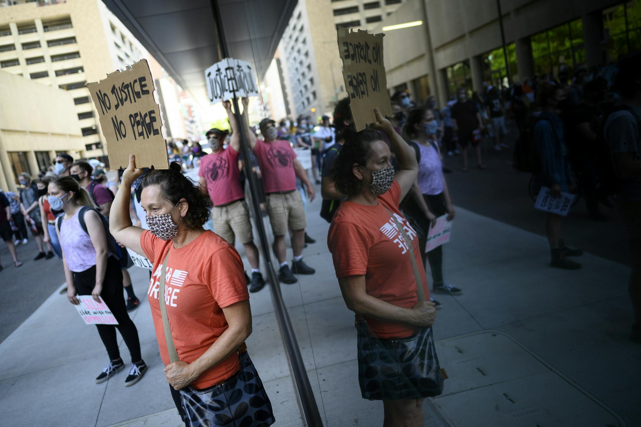 Protesters stood across the street from Minnesota Attorney General Keith Ellison's downtown St. Paul office Friday.