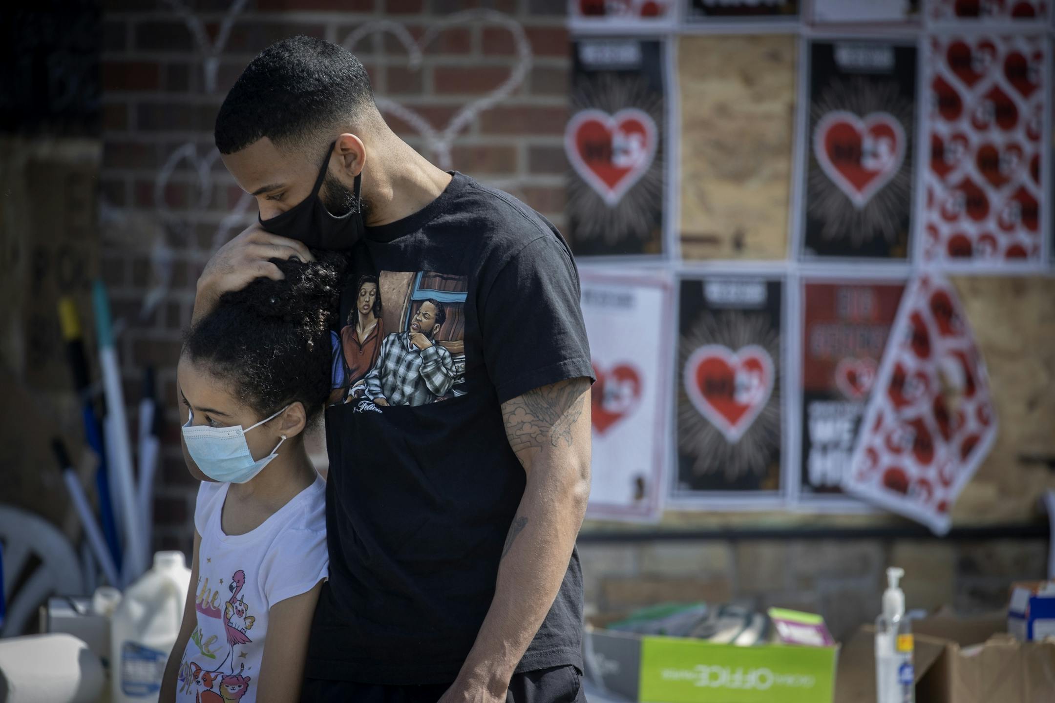 Tevin Craddock, held his little sister LaMya Craddock, 10, close as they visited the scene where George Floyd was killed, Monday, June 1, 2020 in Minneapolis.