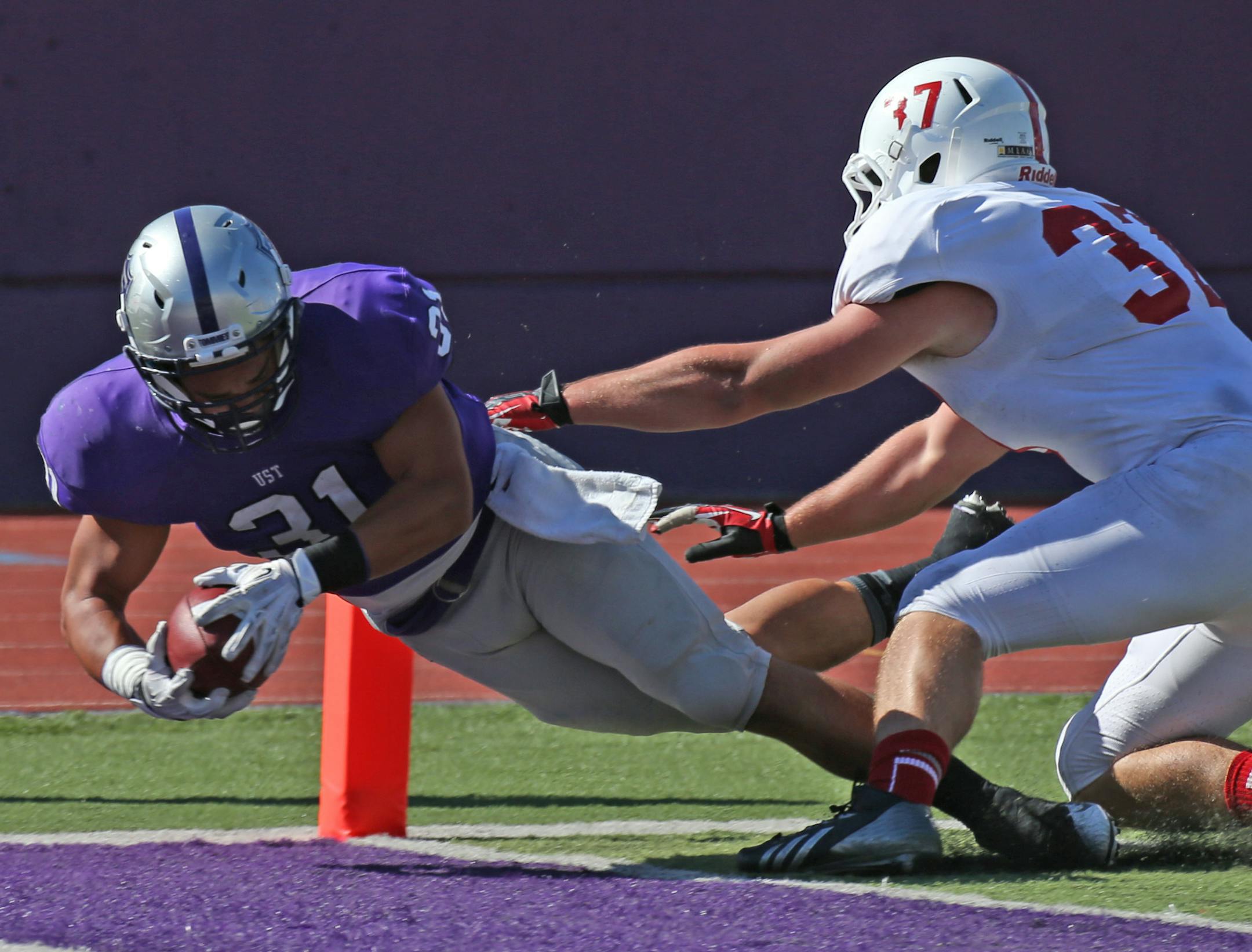 St. Thomas vs. St. Johns, St. Paul, MN., 9/21/13. (left to right) St. Thomas Dominic Truoccolo dove in for a 2nd half touchdown as St. John's Drake Matuska defended] Bruce Bisping/Star Tribune bbisping@startribune.com Dominic Truoccolo, Drake Matuska ORG XMIT: MIN1309211659081213