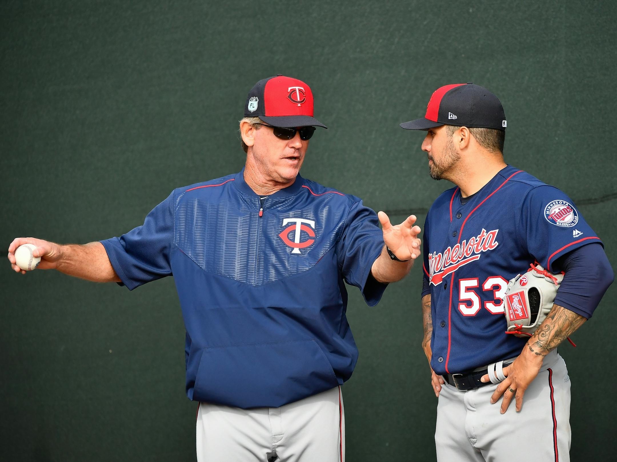 Twins pitching coach Neil Allen talked to pitcher Hector Santiago during a bullpen session Thursday.