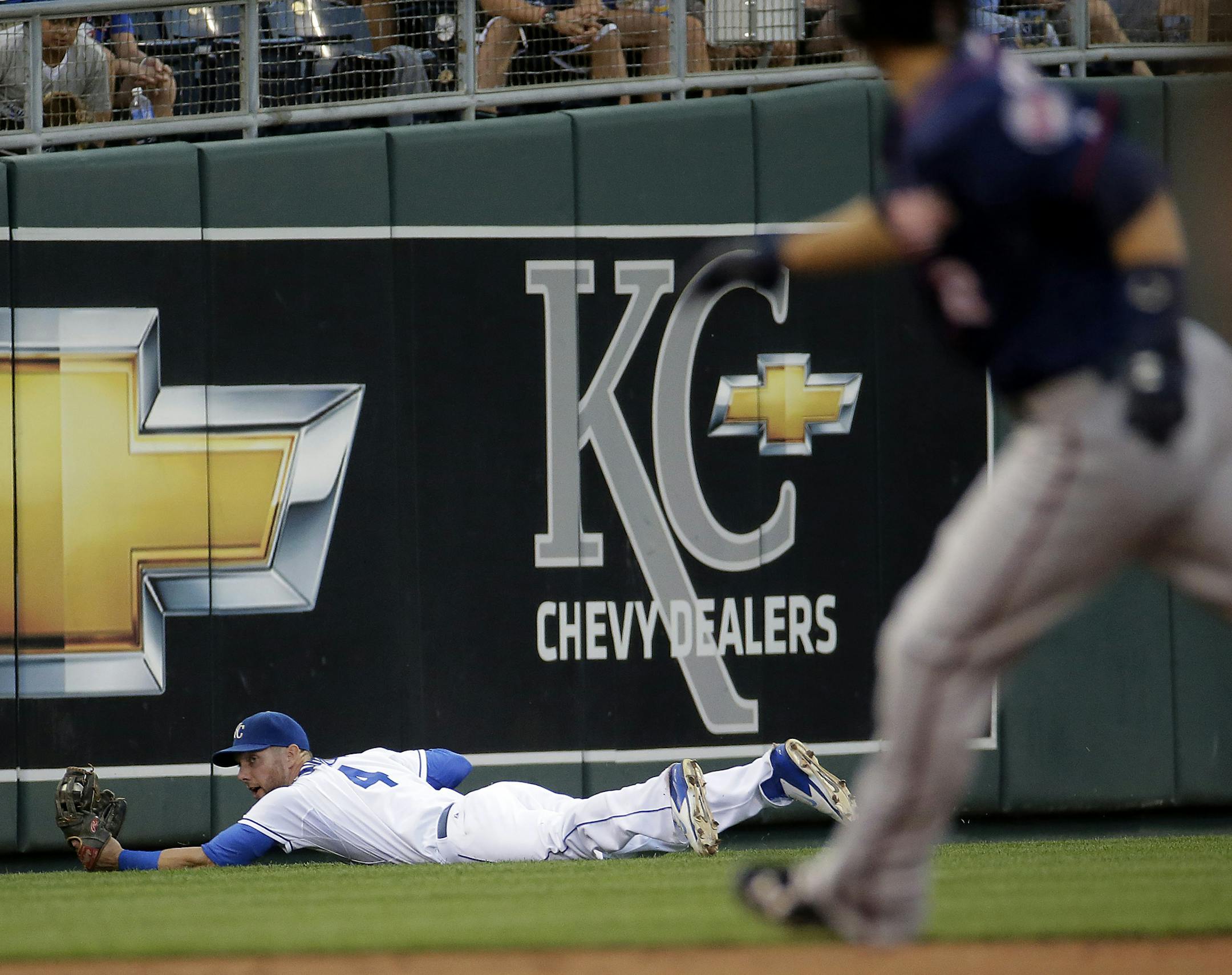 Kansas City Royals left fielder Alex Gordon catches a fly ball hit by Minnesota Twins' Chris Parmelee during the third inning of a baseball game Tuesday, July 29, 2014, in Kansas City, Mo. (AP Photo/Charlie Riedel)
