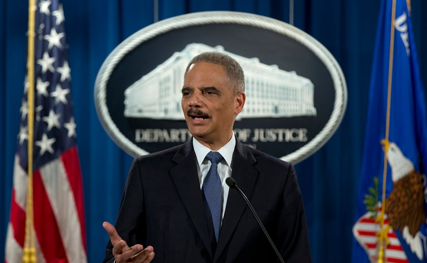 Attorney General Eric Holder spoke at the U.S. Justice Department in 2015 to discuss the fatal shooting of Michael Brown in Ferguson, Mo., in 2014. Having investigated, the department found no basis to prosecute a white former police officer in the death of the unarmed black 18-year-old but released a report faulting the city for racial bias.