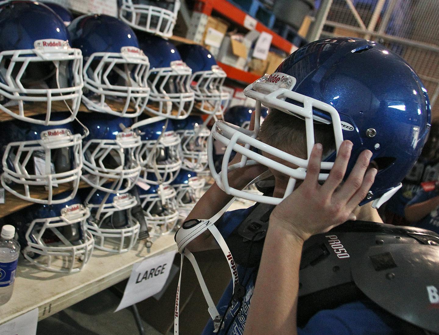 The Woodbury Athletic Association, which sponsors youth football, held signups for youth football recently with time trials and issuing of equipment for youth, and a meeting for parents. Story emphasis on helmets and their relationship to football related concussions. Youth tried on recently purchased helmets for a correct fit. (MARLIN LEVISON/STARTRIBUNE(mlevison@startribune.com (cq )