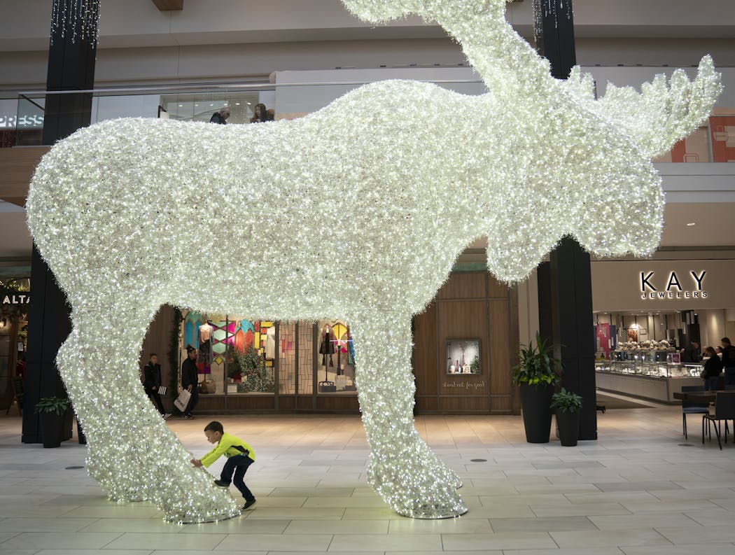 Johnathan Corcoran, 4, walked under a large moose made out of Christmas lights on display in the middle of Rosedale Center in Roseville on Friday.