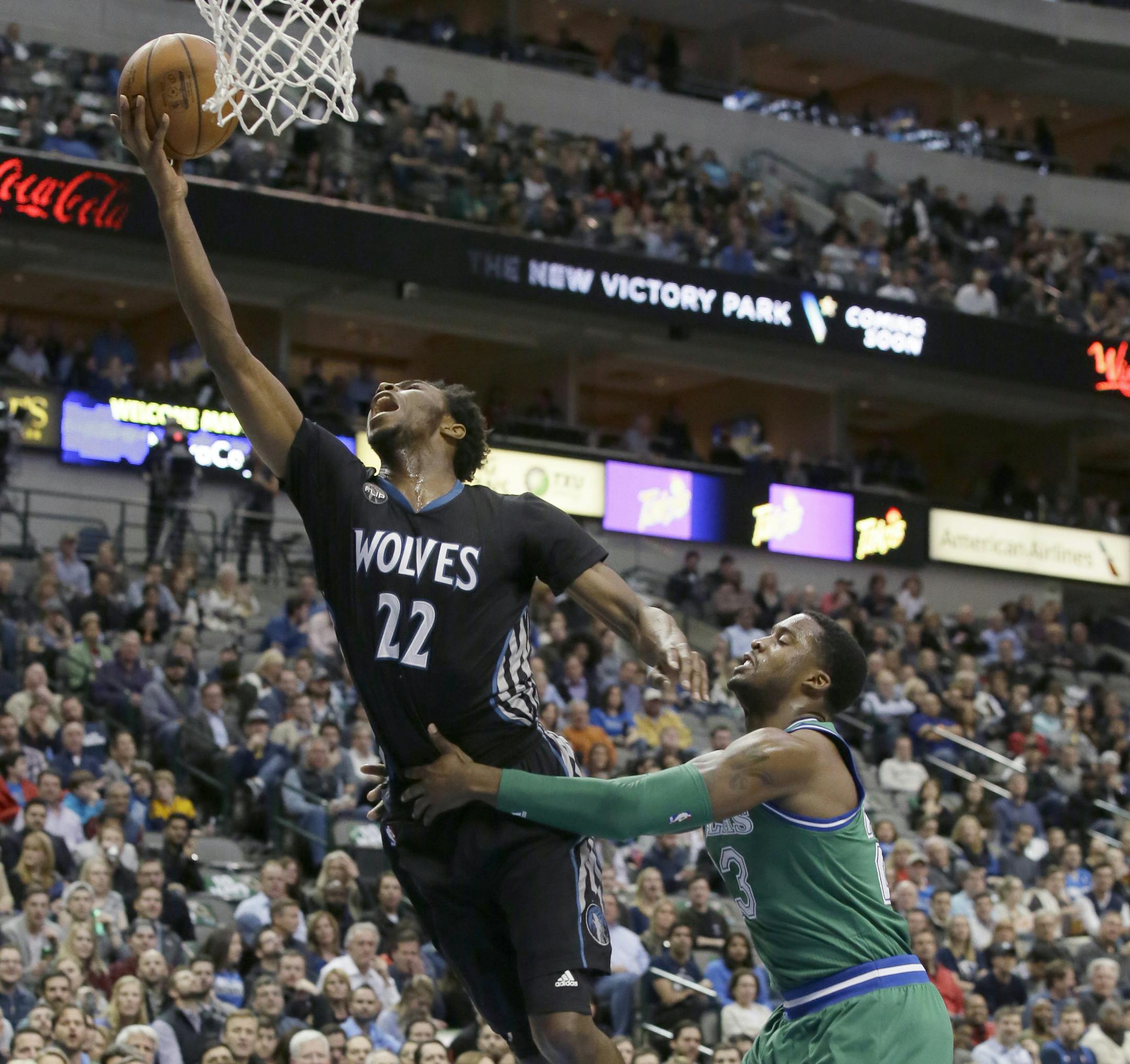 Minnesota Timberwolves guard Andrew Wiggins (22) is fouled by Dallas Mavericks guard Wesley Matthews (23) during the first half of an NBA basketball game Wednesday, Jan. 20, 2016, in Dallas. (AP Photo/LM Otero)
