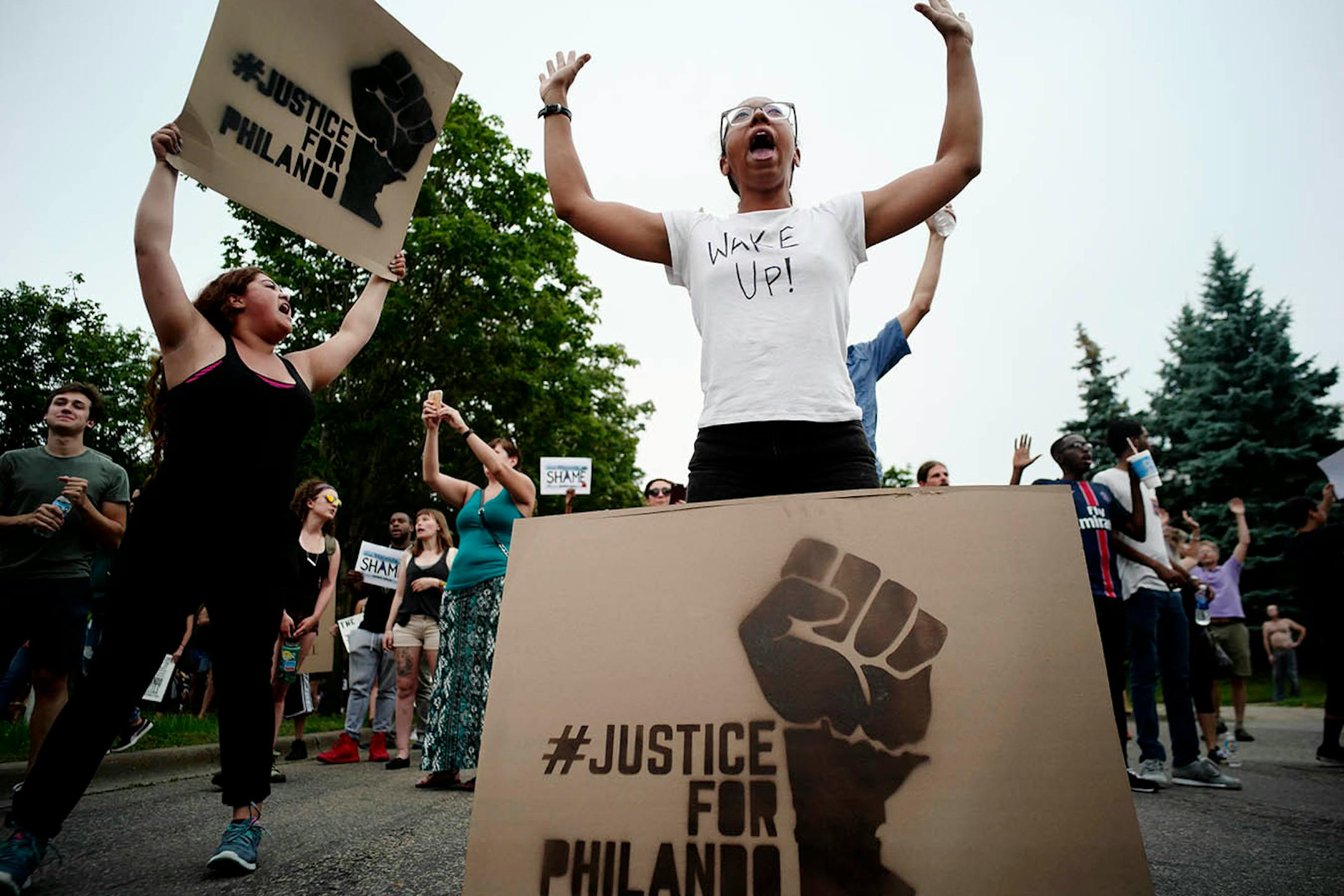 Protesters including Rachel Olzer, right, took to the street and marched to JJ Hill Montessori School where a vigil was being held.