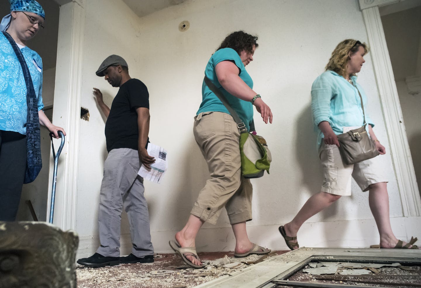 During the Dayton's Bluff Vacant Home Tour in St. Paul, most of the six vacant homes are in rough shape including this one at 737 Plum. Sue Rhea, far left, lives in the neighborhood and was curious as to how those homes looked inside.] Richard Tsong-Taatarii/rtsong-taatarii@startribune.com