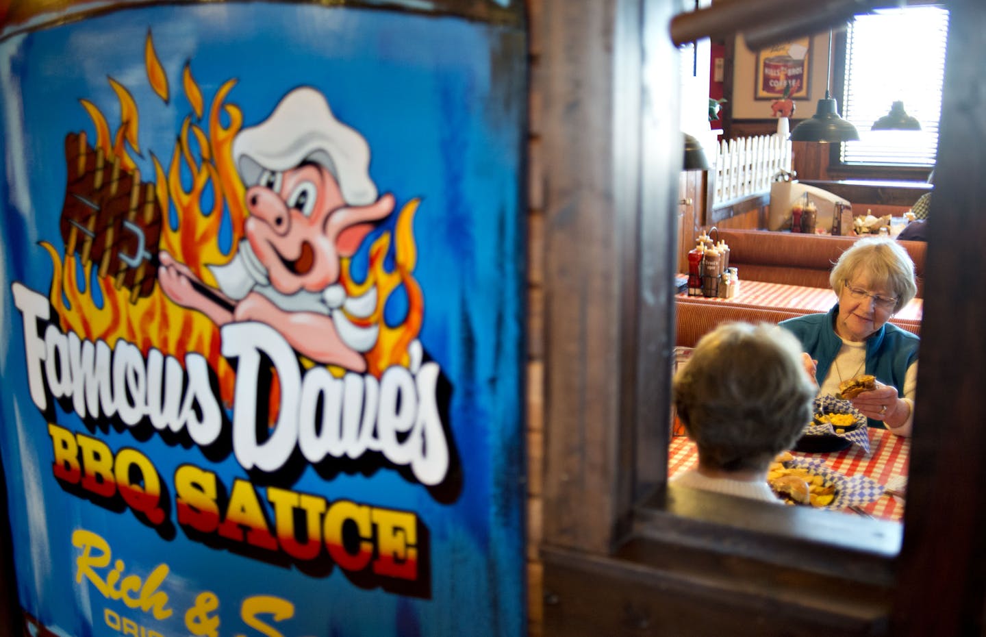 Customer Neta Moon, right, eats with a friend at a Famous Dave's restaurant.