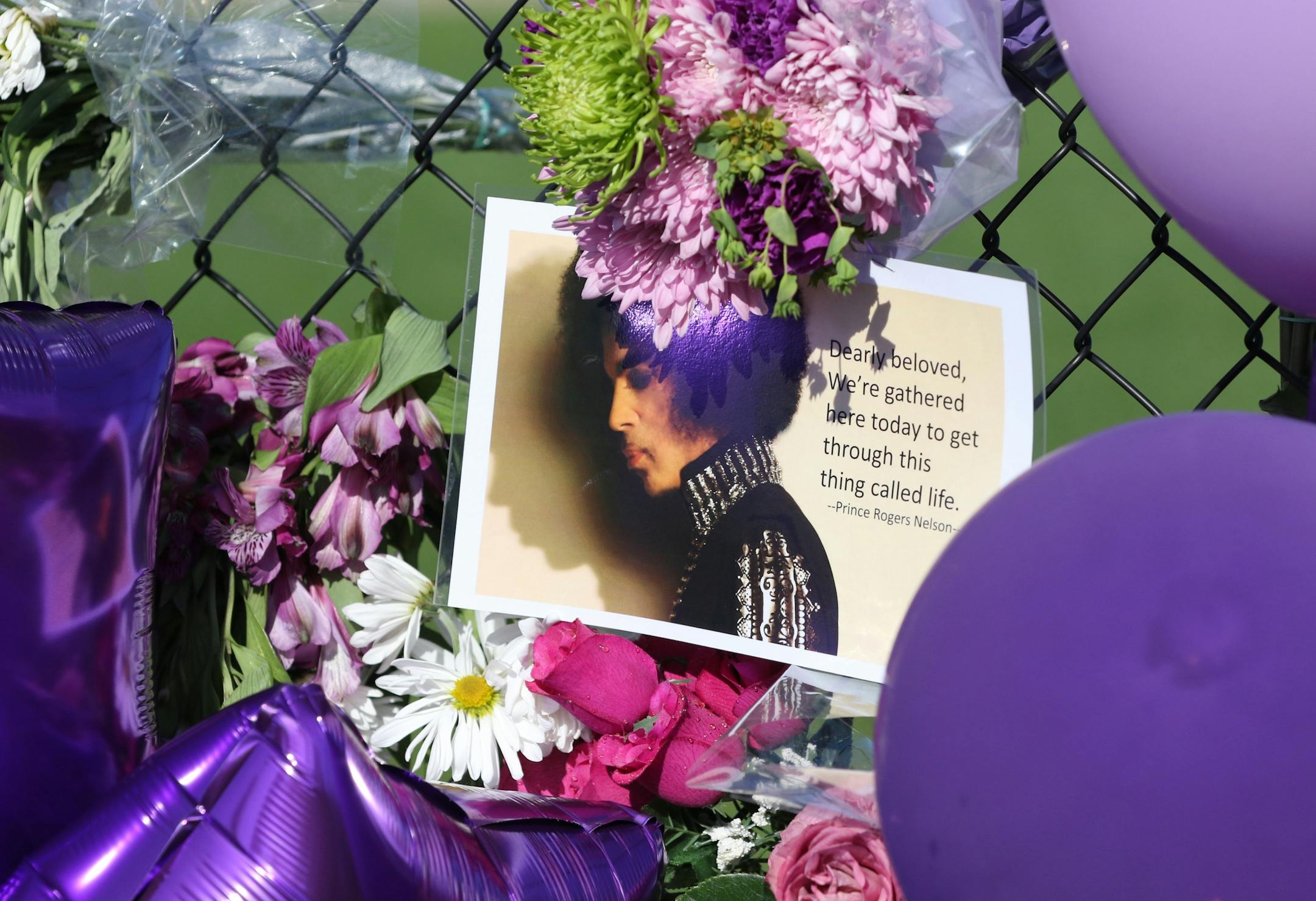 Balloons, flowers and cards on a memorial fence outside Paisley Park Studios Friday, April 22, 2016, in Chanhassen, MN. Prince died there Thursday at the age of 57. Geary said "Prince was one of the most amazing musicians I've ever heard."