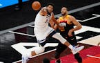 Minnesota Timberwolves center Karl-Anthony Towns (32) and Utah Jazz center Rudy Gobert, right, vie for a rebound during the second half of an NBA bask