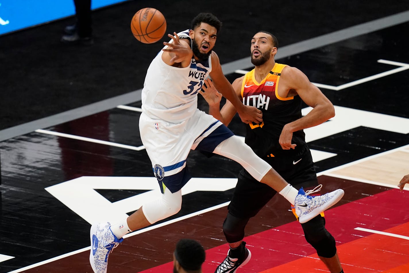 Minnesota Timberwolves center Karl-Anthony Towns (32) and Utah Jazz center Rudy Gobert, right, vie for a rebound during the second half of an NBA basketball game Saturday, Dec. 26, 2020, in Salt Lake City. (AP Photo/Rick Bowmer) ORG XMIT: UTRB117