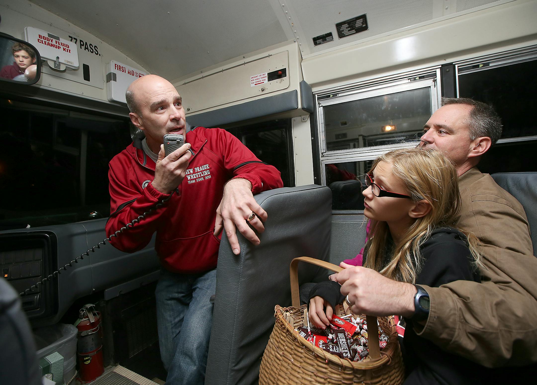 Greg Tikalsky, the son of longtime New Prague Schools bus driver Joseph Tikalsky, spoke to high-schoolers who were getting on the bus, Friday, October 30, 2015 near New Prague, MN. Tikalsky, joined his family to pass out Halloween candy to kids who were on his father's bus route. Holding the candy is his brother Joe Tikalsky the third, right, and Joe's daughter Alena, 11. Joe Tikalsky died Wednesday after being hit by a car when he was returning home from driving his bus route. ] (ELIZABETH FLOR