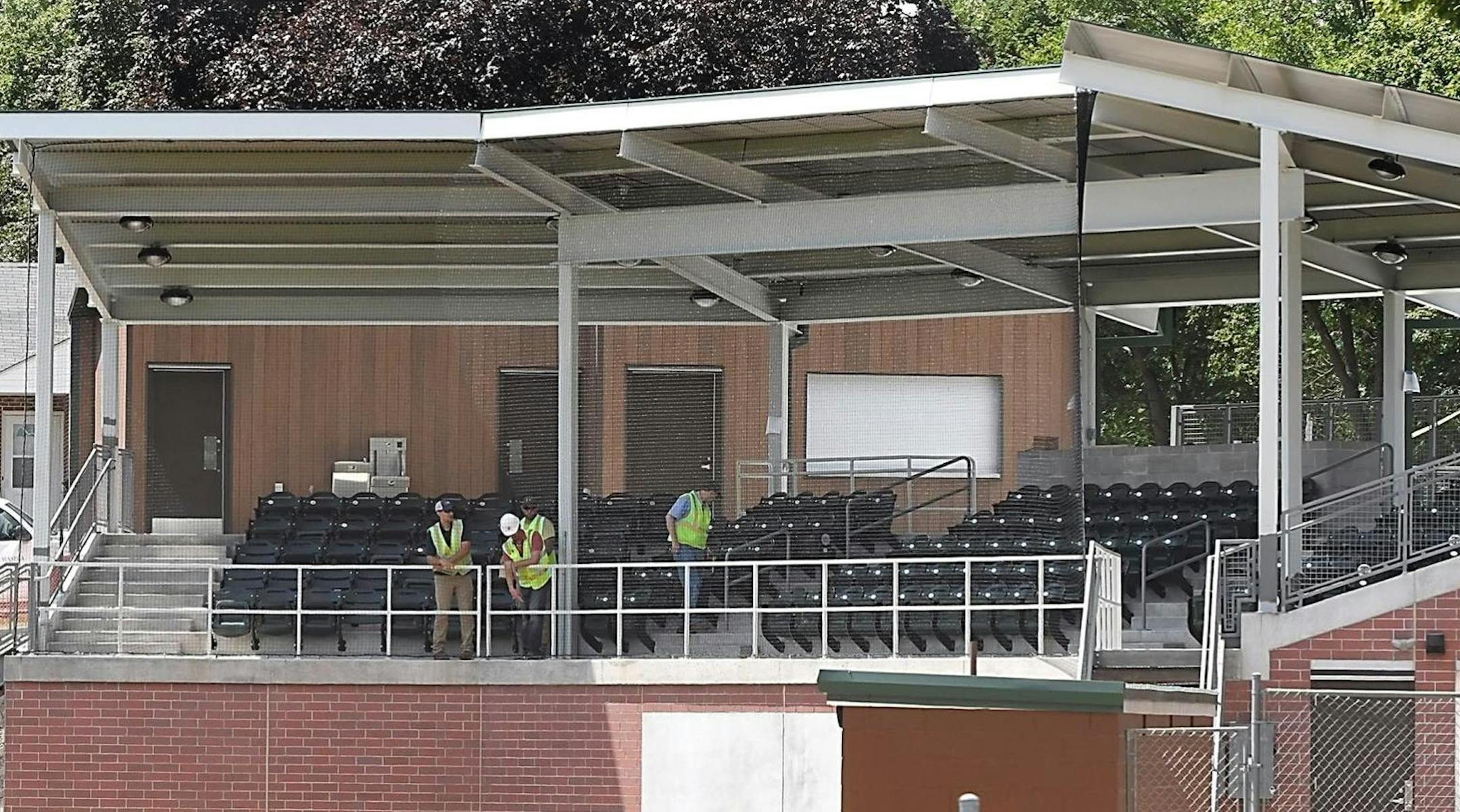 Workers install the last few seats in the new grandstand at Tink Larson Community Field Tuesday in Waseca. More than two years after the old grandstand burned down in an April 2016 fire, the revamped ballpark's grand opening will be Aug. 18. MANDATORY CREDIT: Photo by Pat Christman / The Free Press