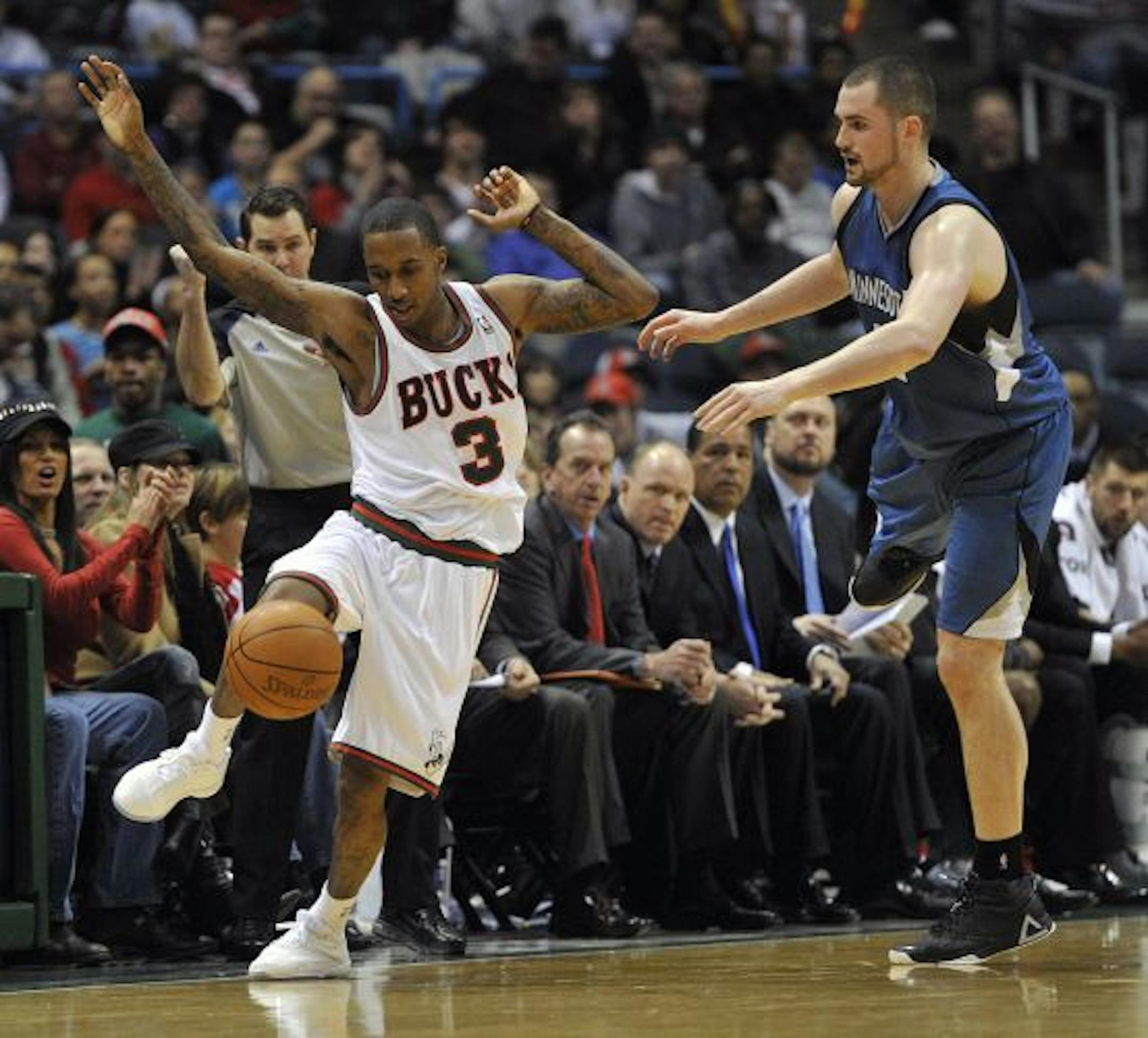Milwaukee Bucks' Brandon Jennings (3) gets fouled by the Minnesota Timberwolves' Kevin Love during the second half of an NBA basketball game Tuesday, Feb. 22, 2011, in Milwaukee. The Bucks defeated the Timberwolves 94-88.
